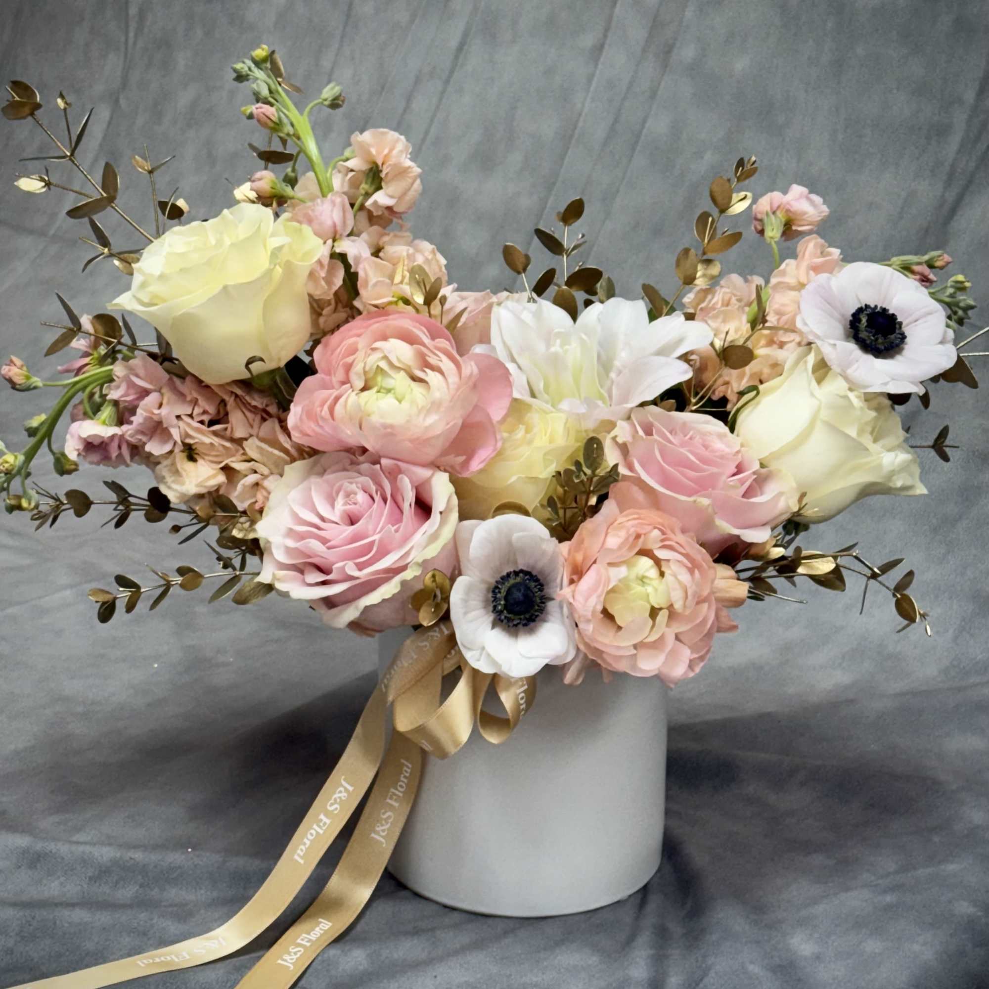 Golden Grace
Soft blush, ivory, and peach blooms paired with golden accents create