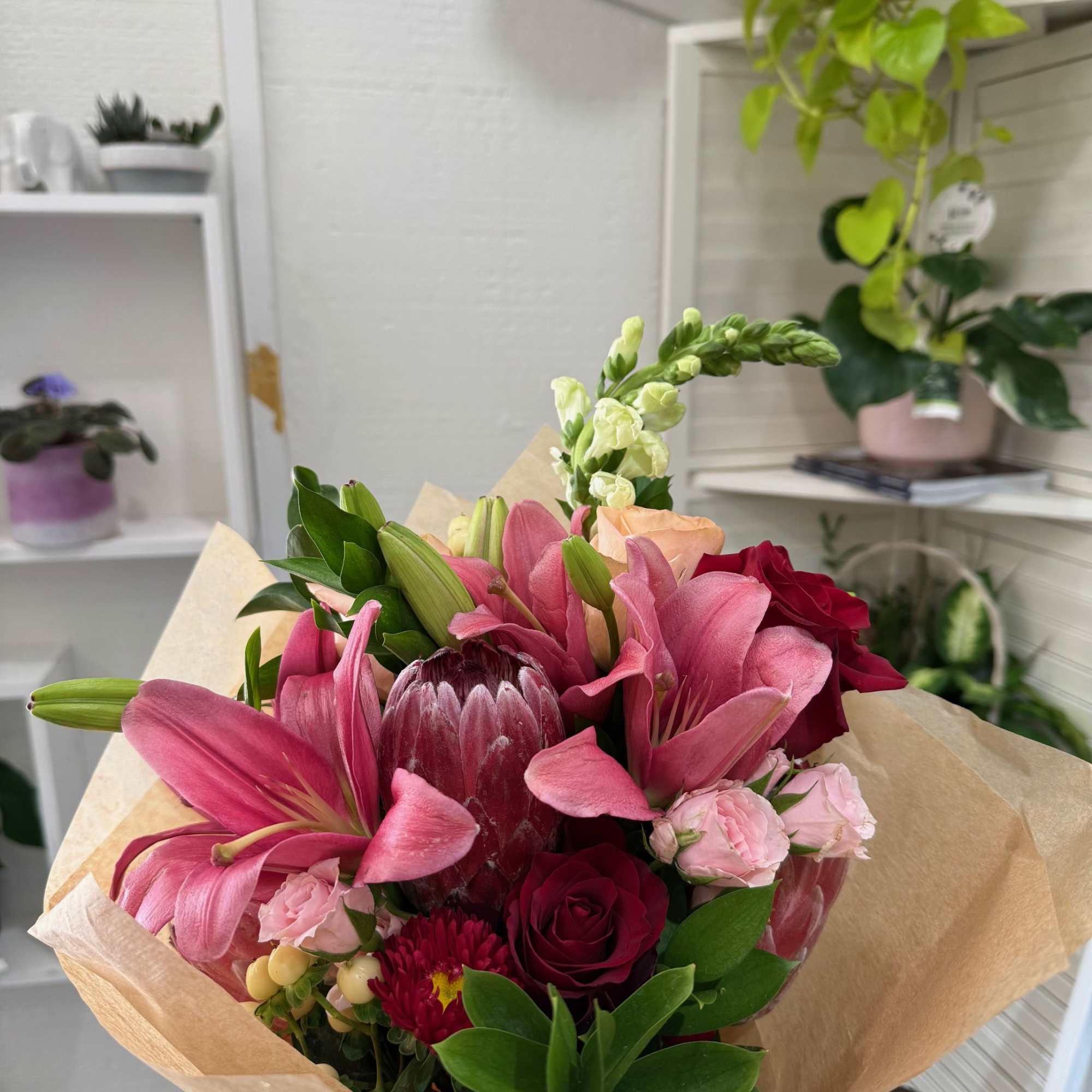 A breathtaking mix  of classic lilies and elegant roses, artfully wrapped