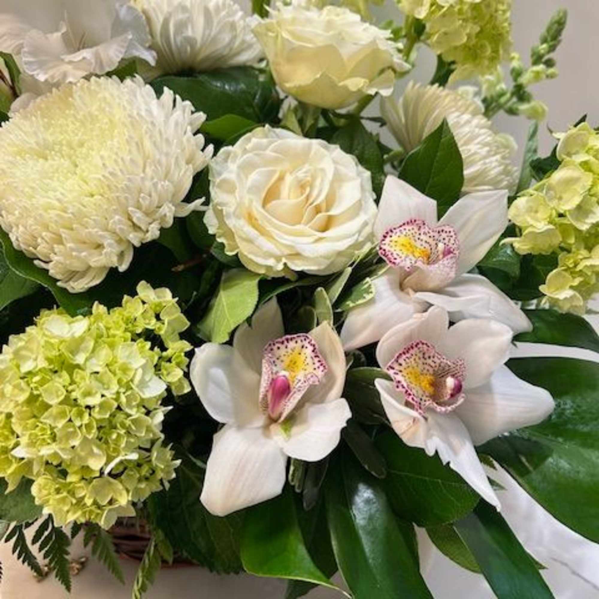 A serene basket filled with pristine white flowers, designed to offer comfort