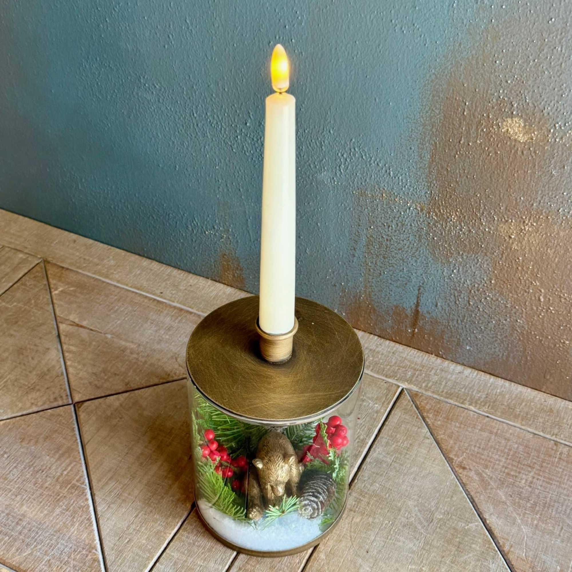 This glass and gold colored candle holder with removable seasonal decor and