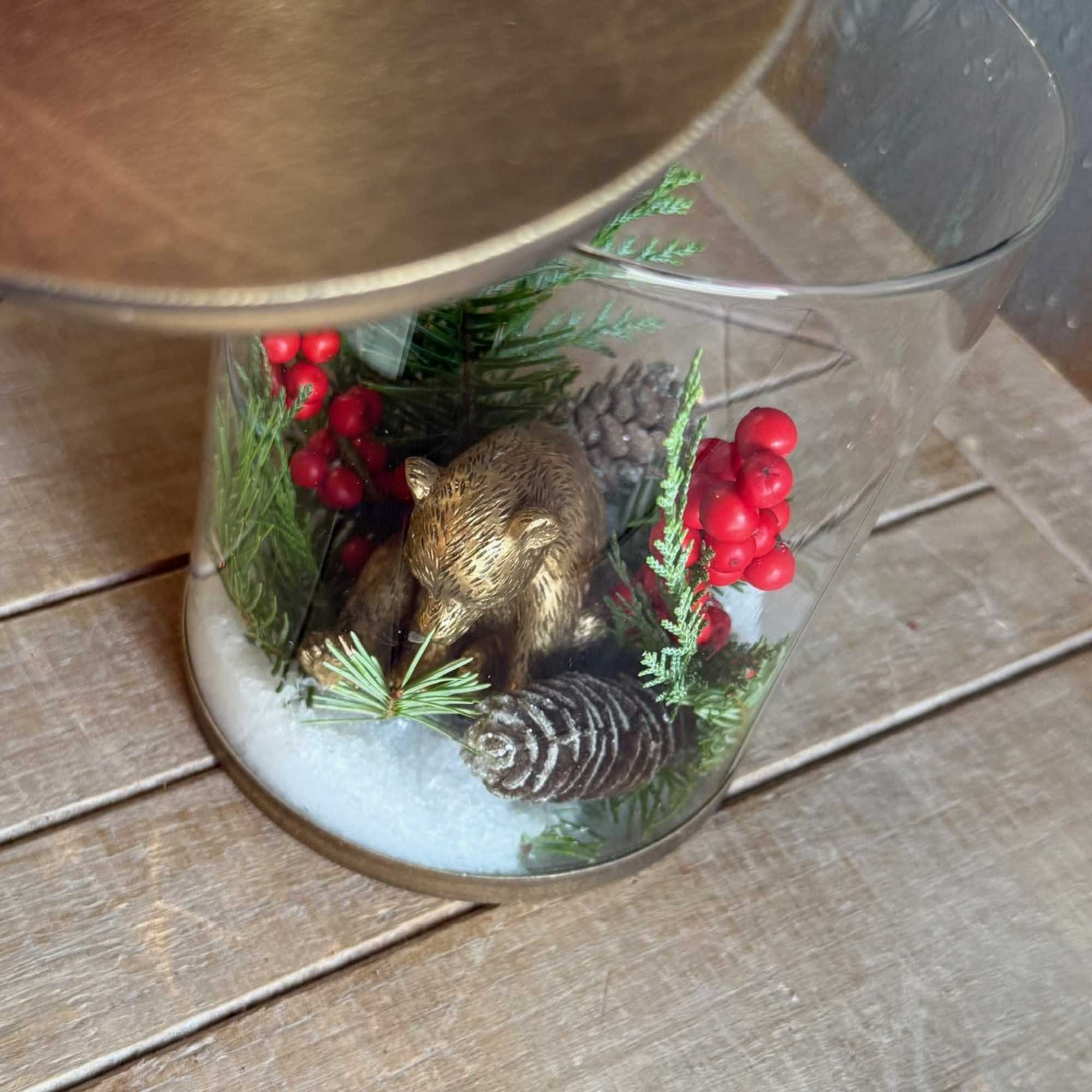 This glass and gold colored candle holder with removable seasonal decor and