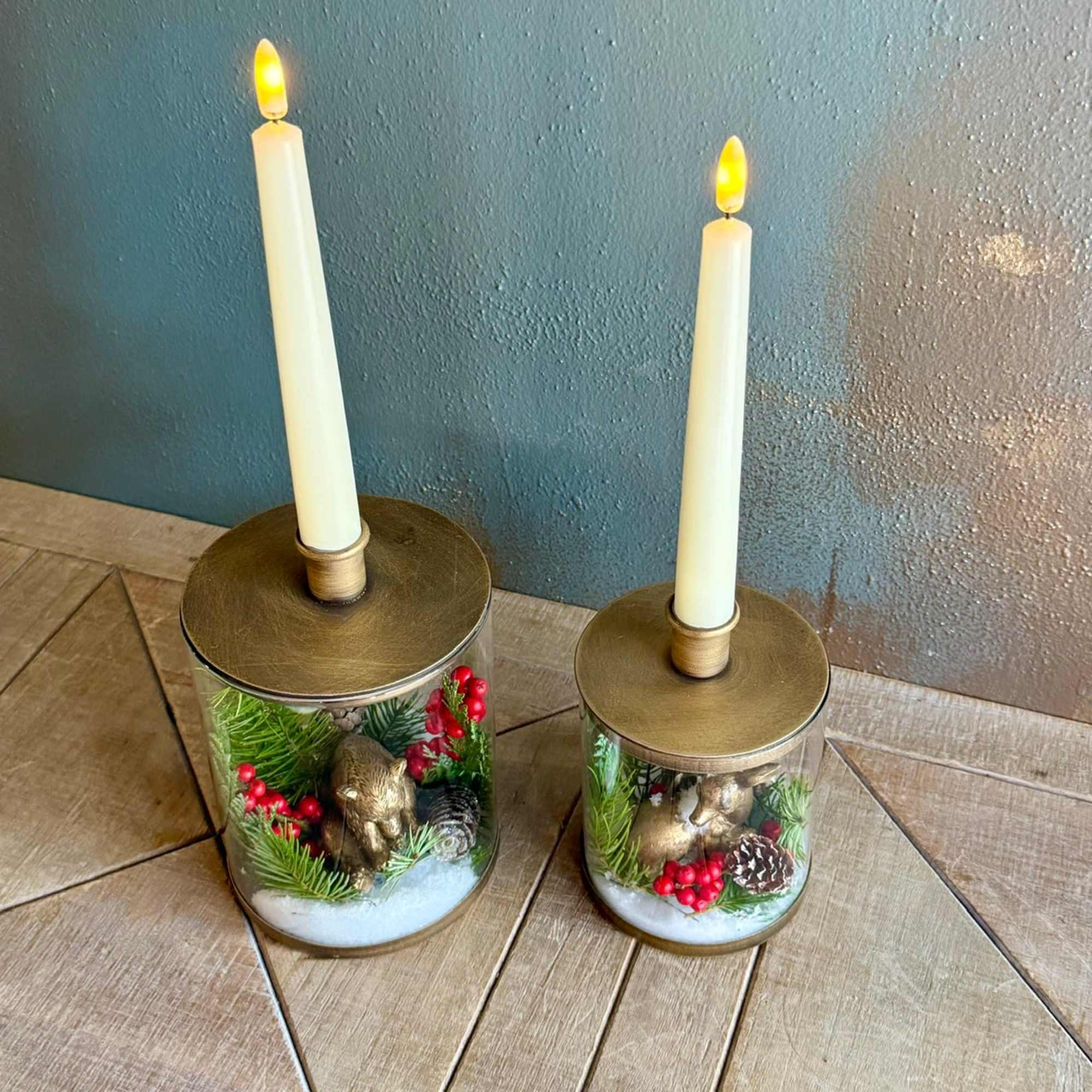 This glass and gold colored candle holder with removable seasonal decor and