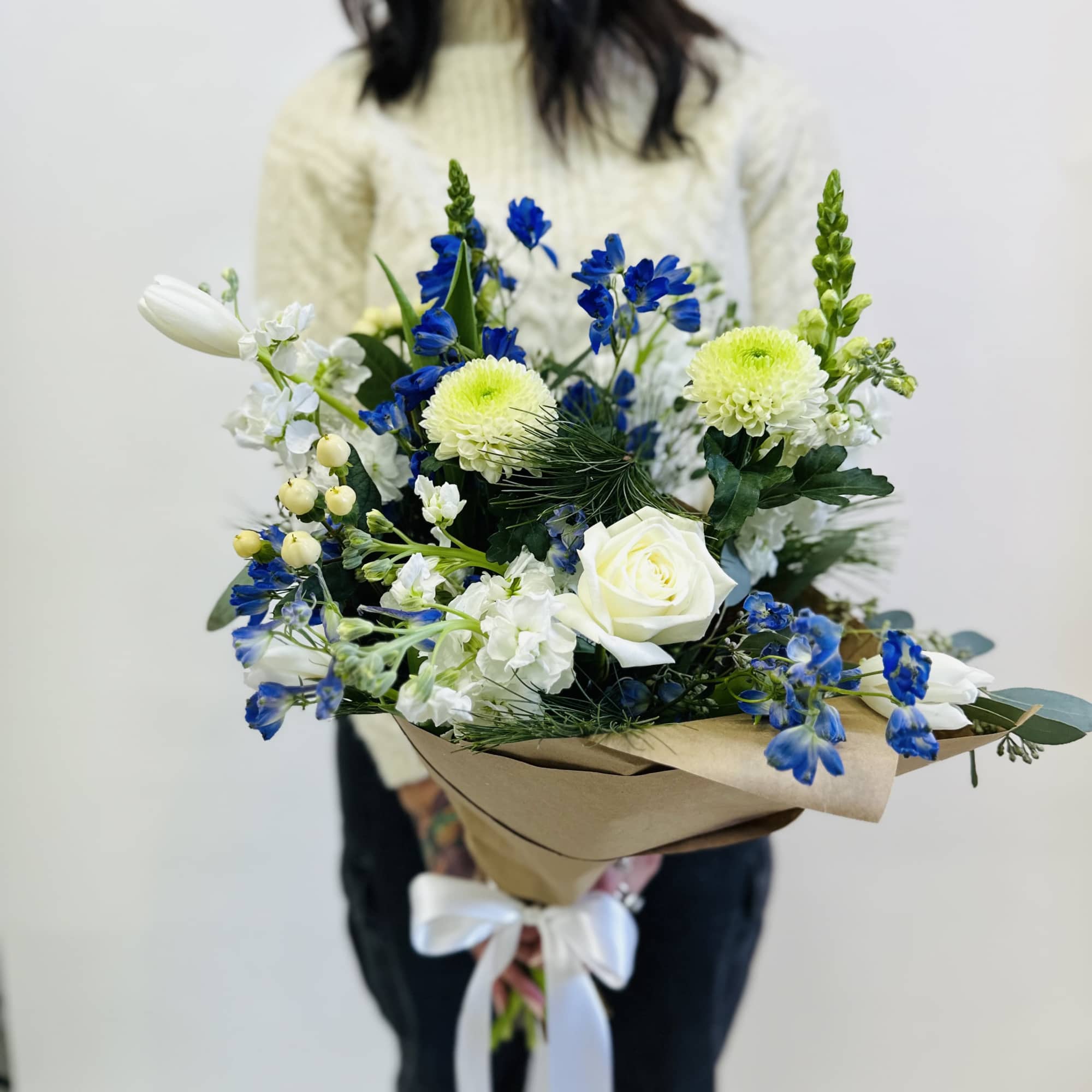 A burst of blue and white blooms with lush greenery, ready to