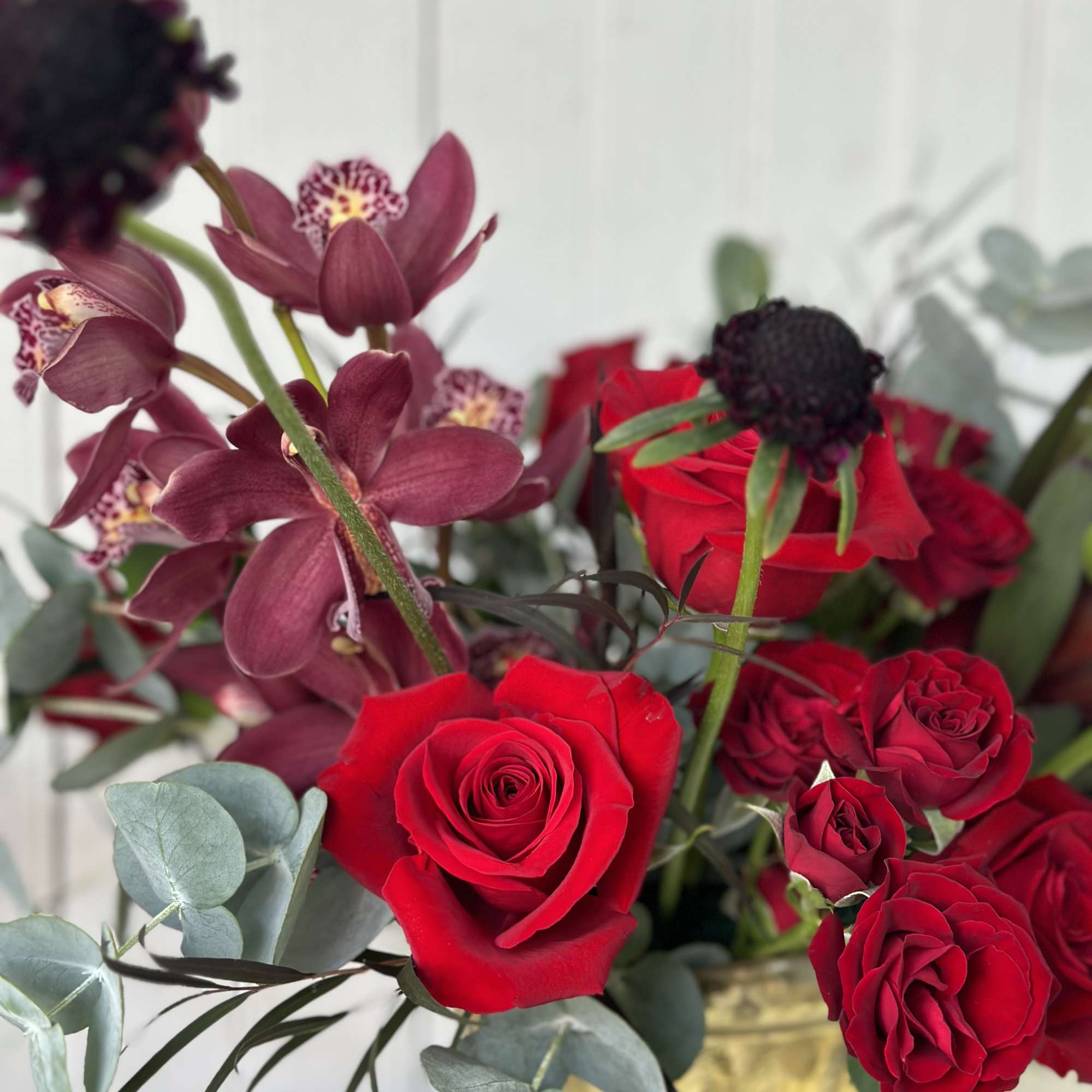 This keepsake gold glass compote is filled with premium blooms. 