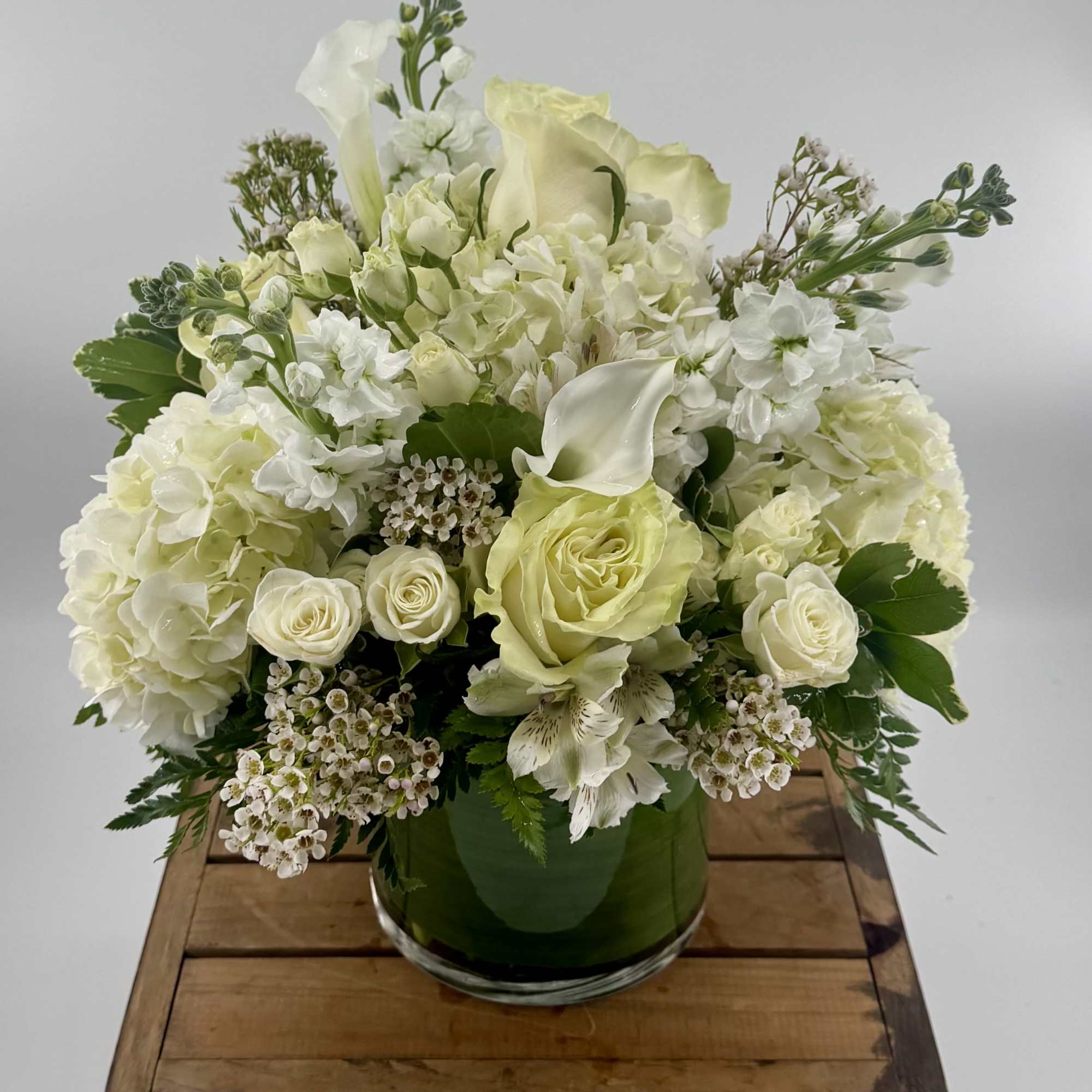 Indulge in the delicate beauty of the "Vanilla Blossom" arrangement, a luxurious