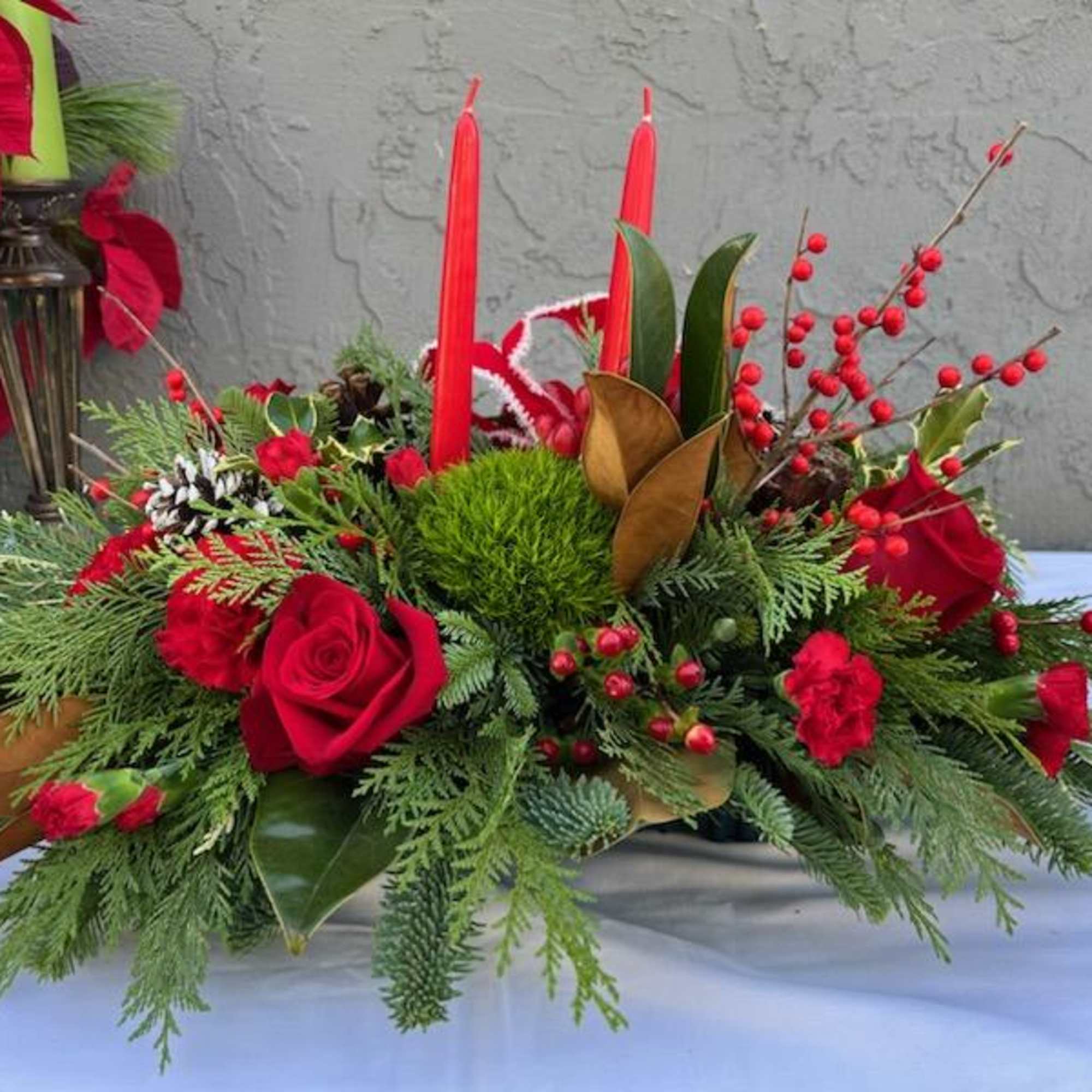 A beautiful centerpiece for Christmas, with a red ribbon and two red