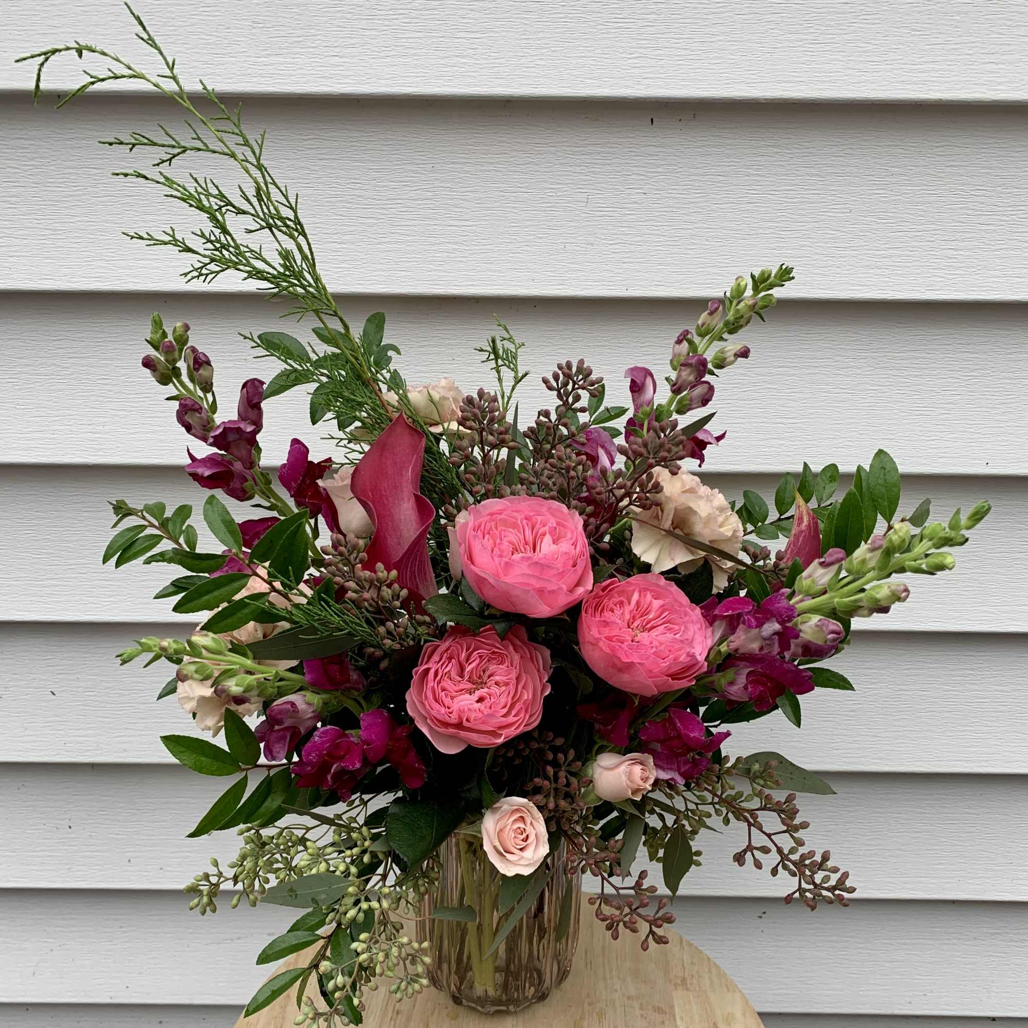 A sweet and whimsical take on holiday florals. Soft pink and rich