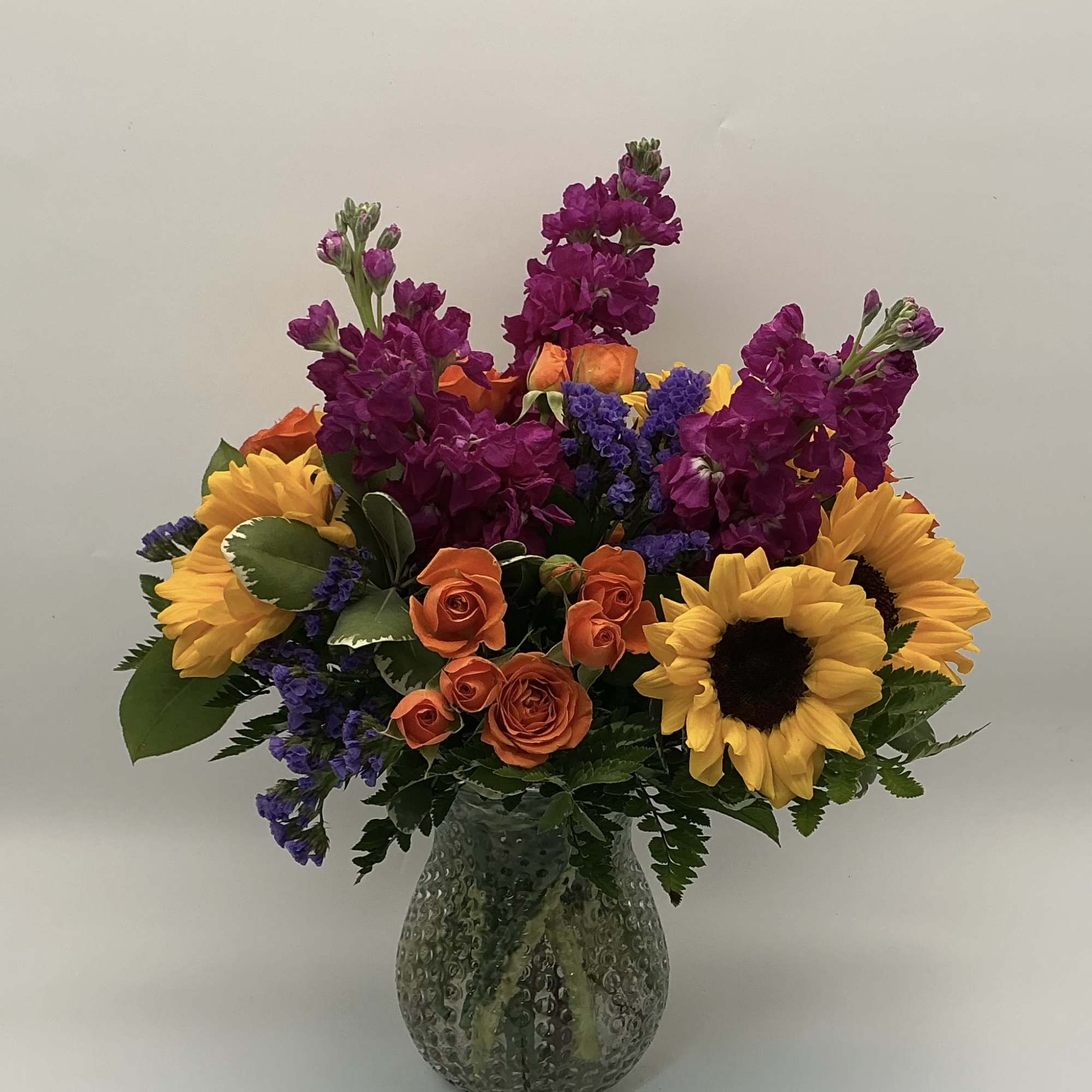 A bouquet that reflects a vibrant Charleston landmark. With yellow sunflowers, orange