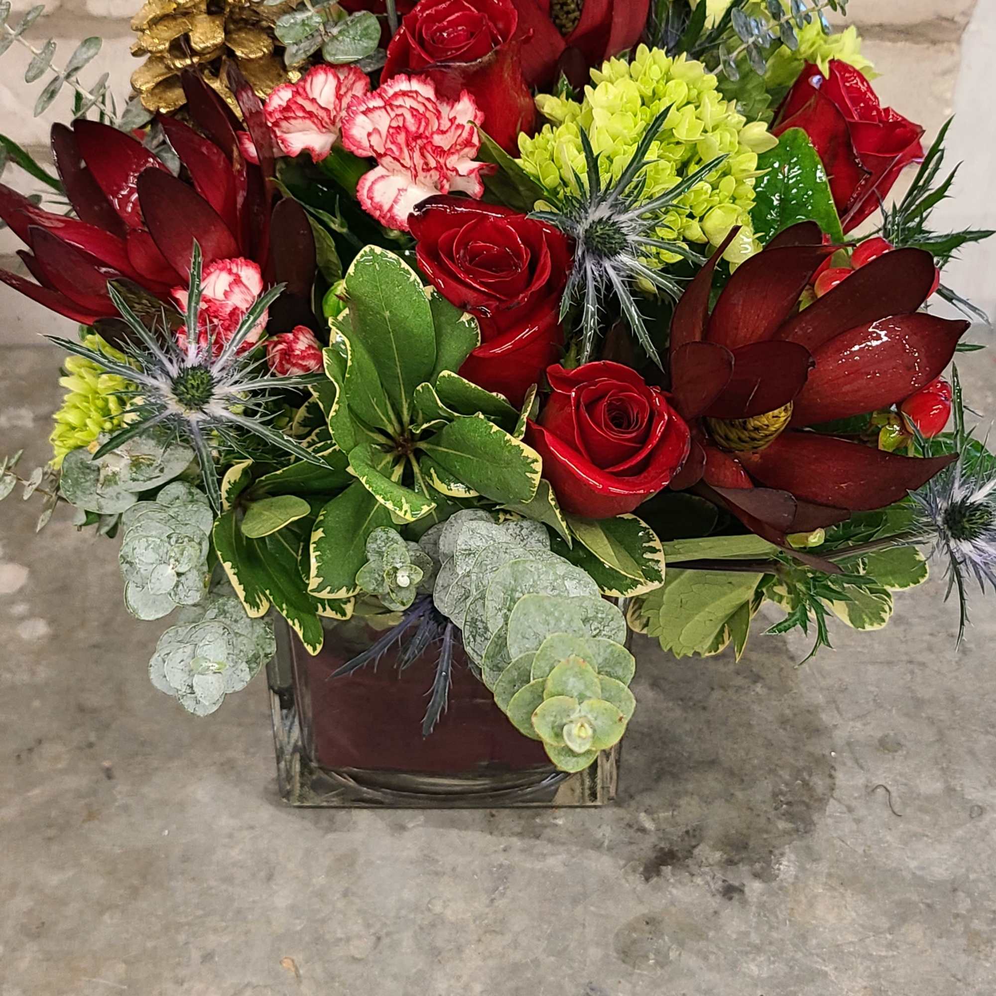 A cute vase decorated with a red leaf inside the vase plus