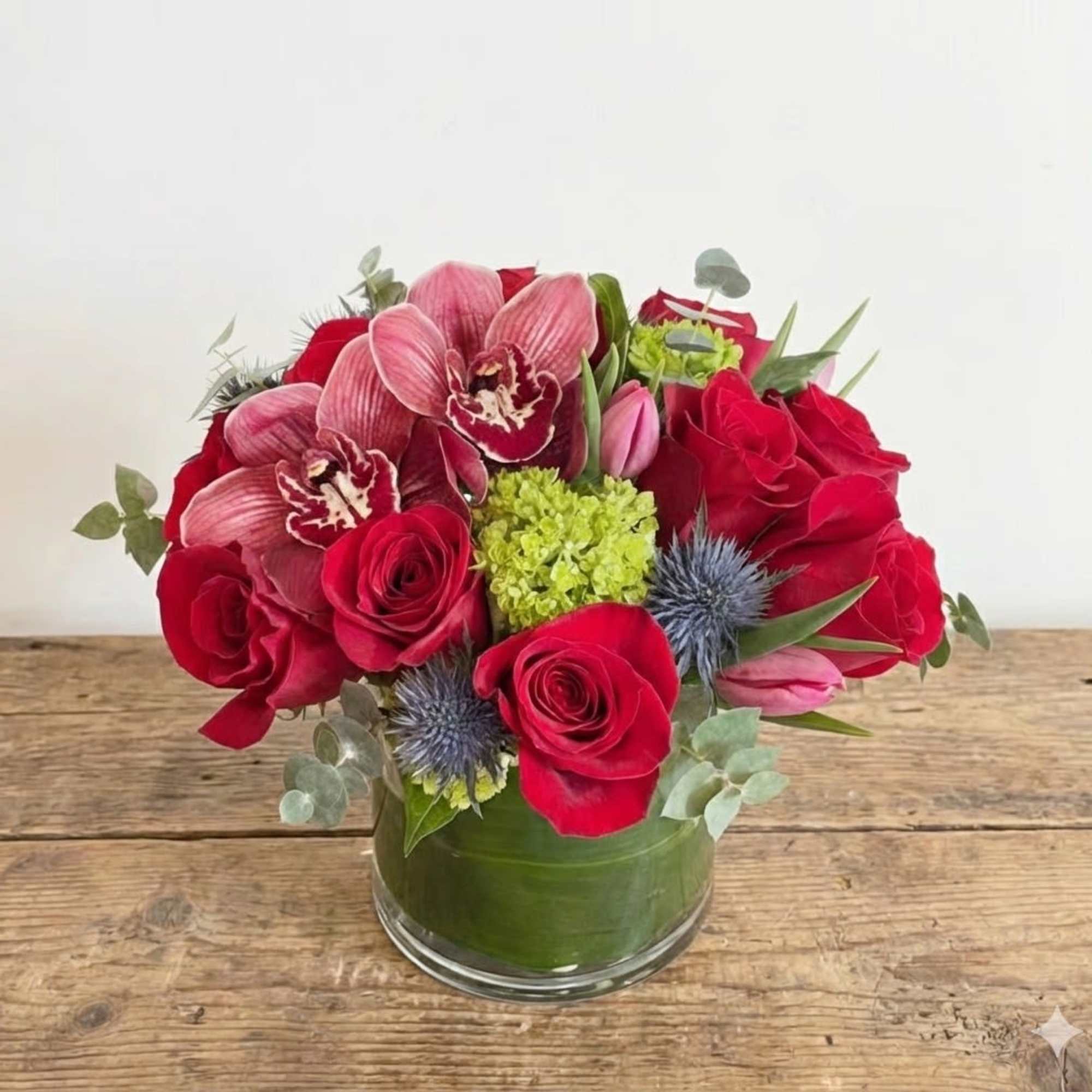 This Mega includes premium roses, thistles, burgundy or green color cymbidium orchid