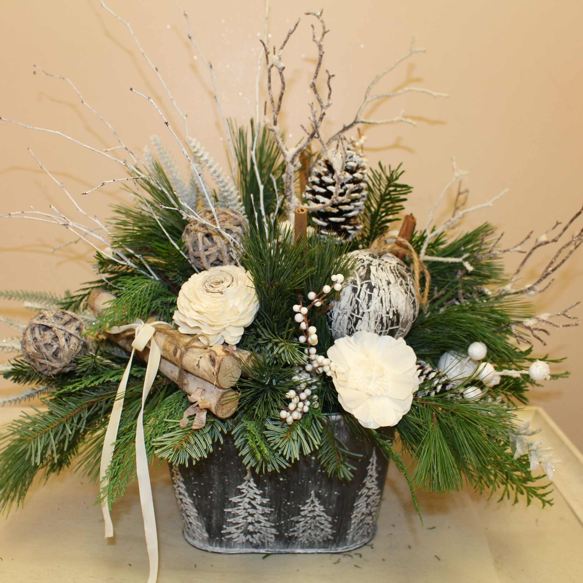 A galvanized container with edged trees is filled with balsam, pine, cedar