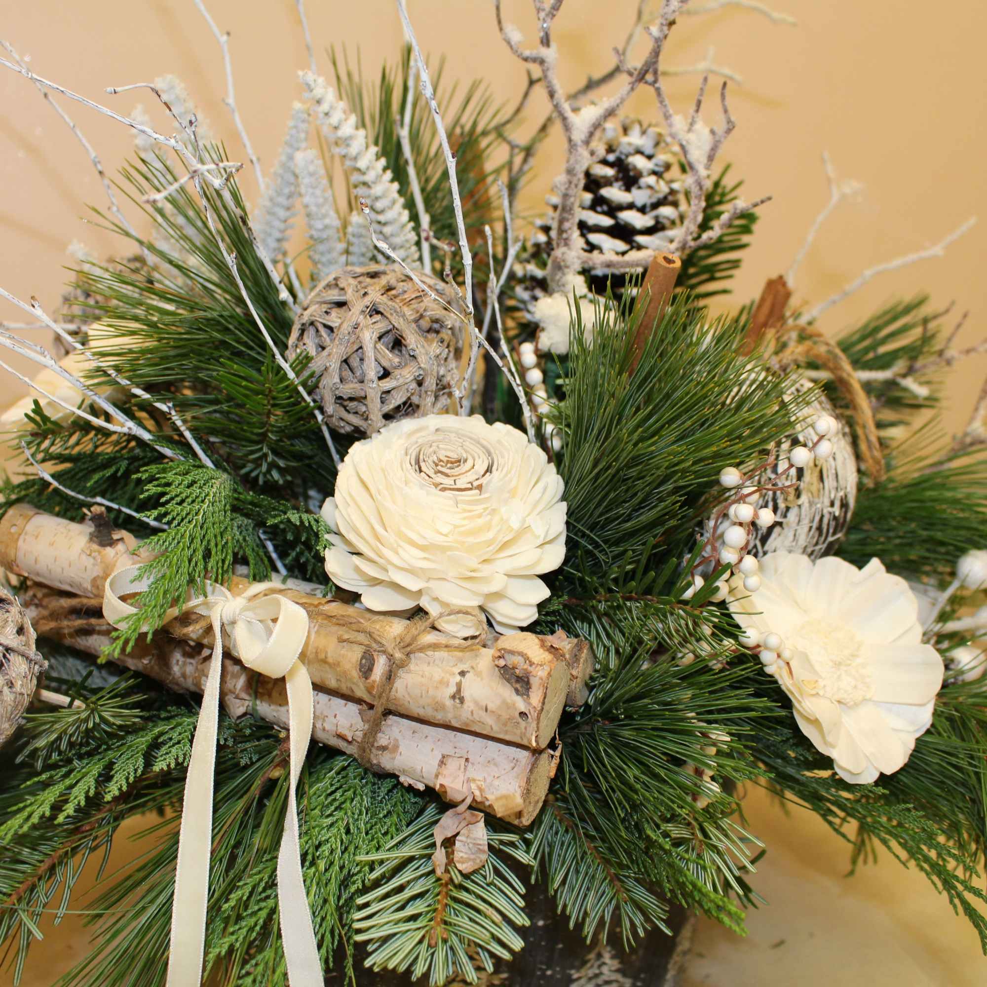 A galvanized container with edged trees is filled with balsam, pine, cedar