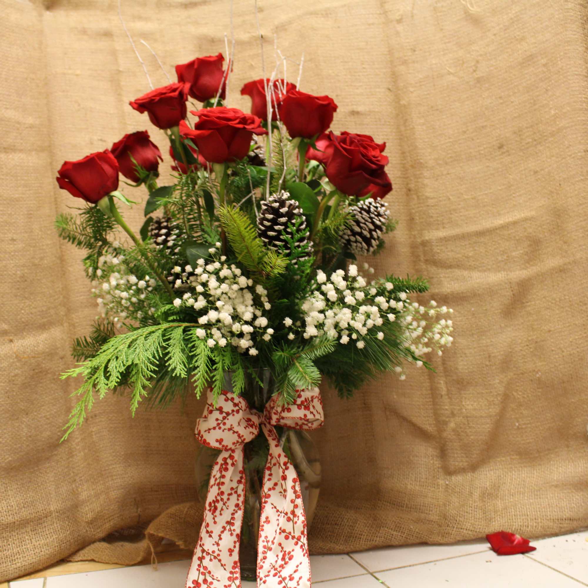 A vase arrangement with beautiful red roses and fragrant white carnations mixed