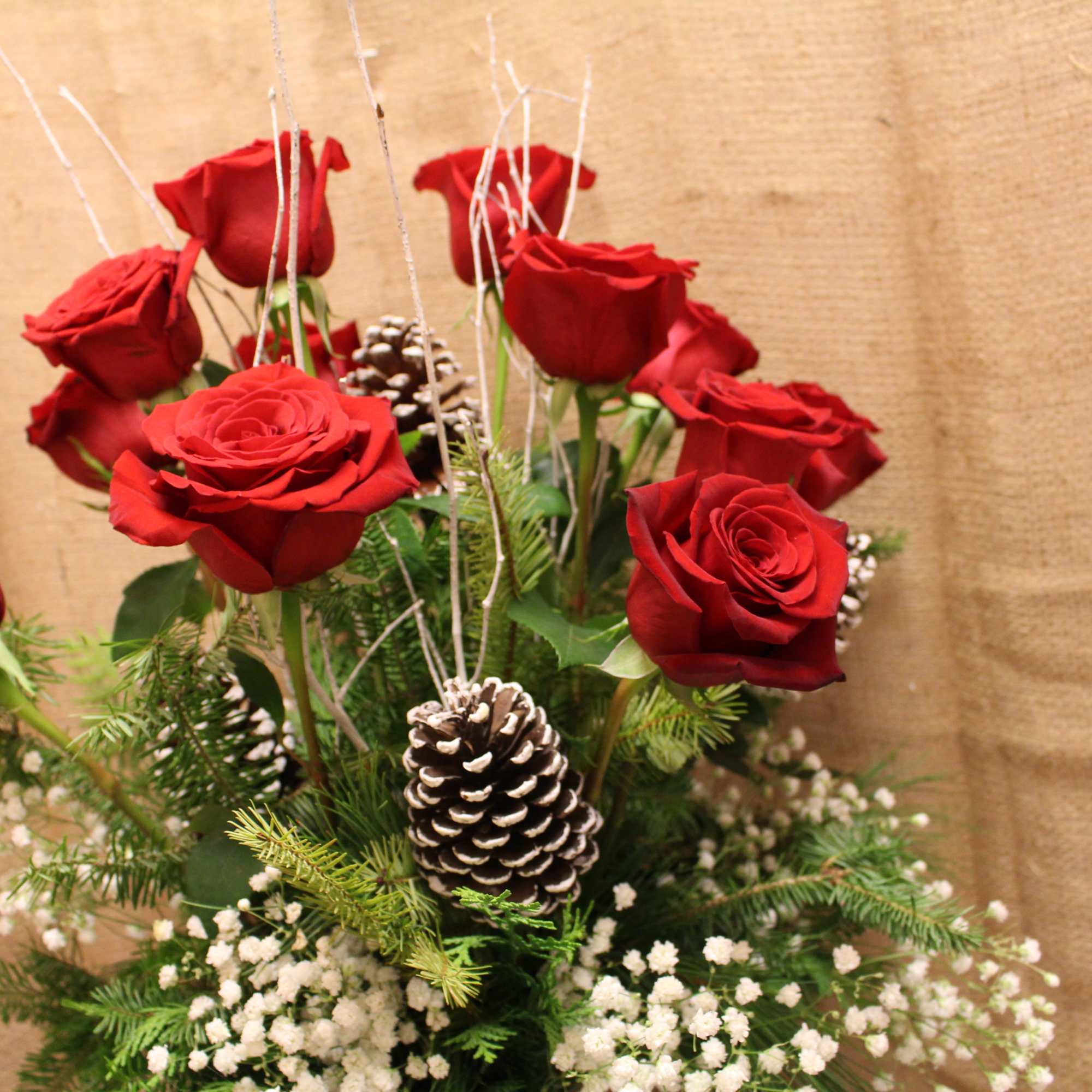 A vase arrangement with beautiful red roses and fragrant white carnations mixed
