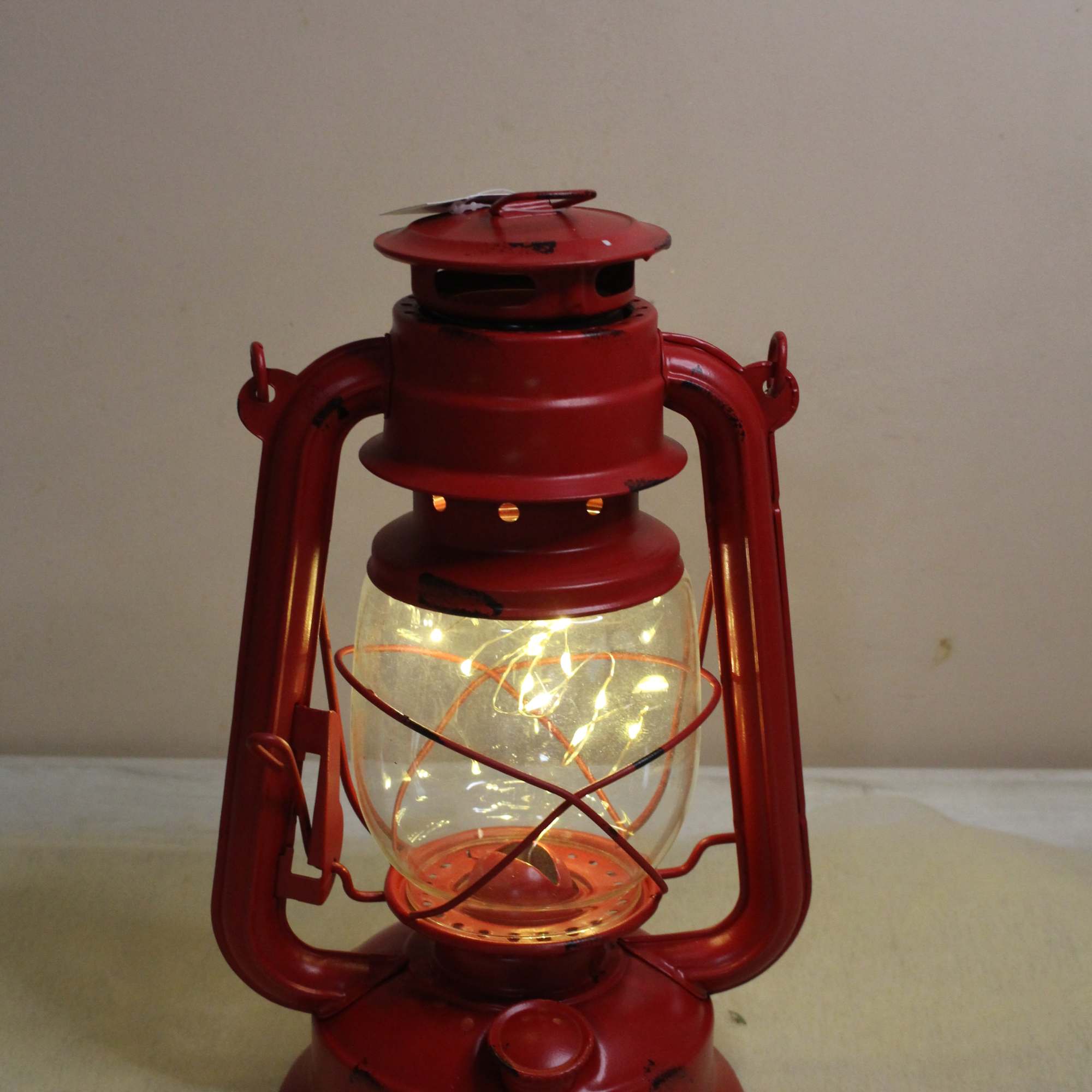 Unique old fashion lantern surrounded by a lovely Christmas arrangement.  