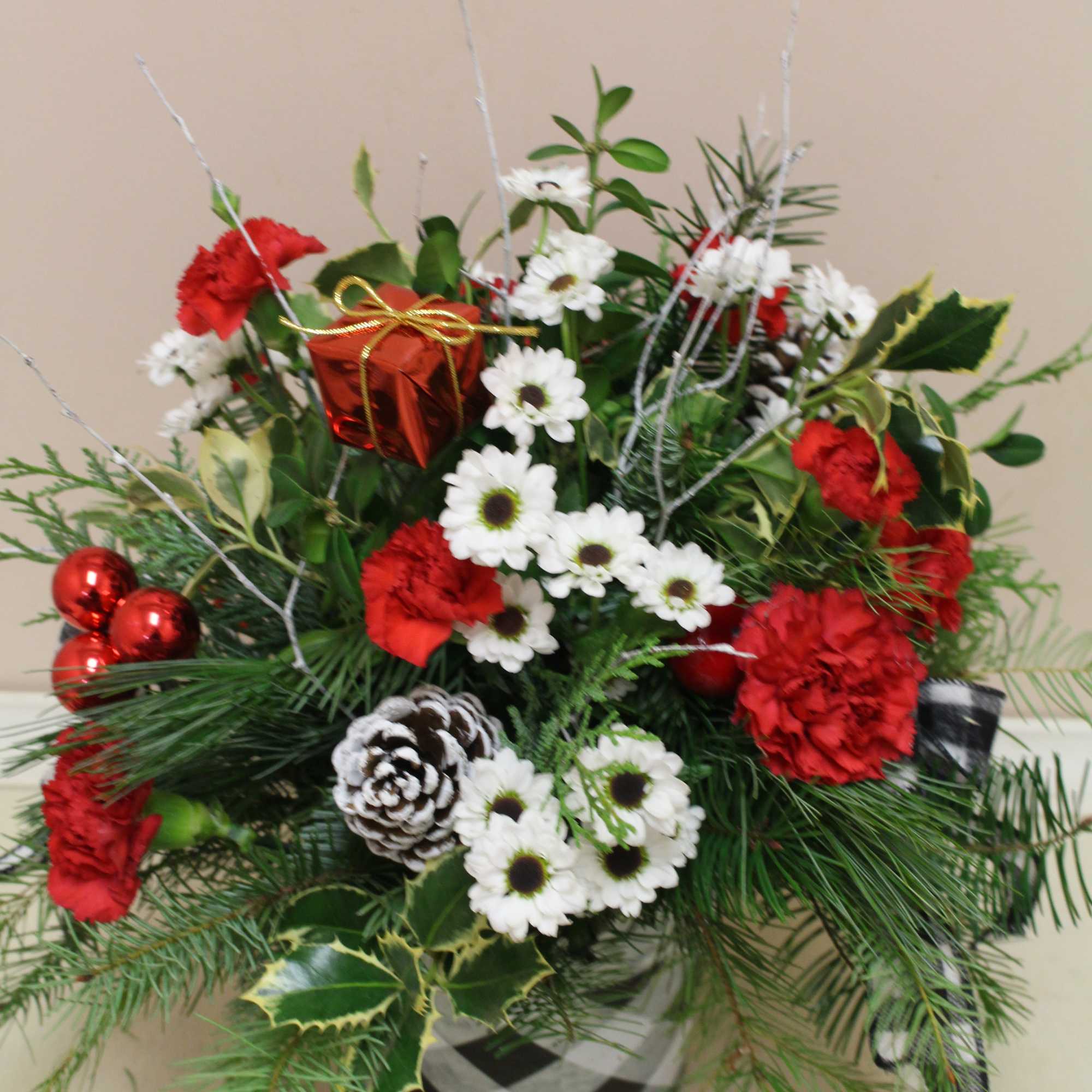 A beautiful holiday arrangement in a black and white galvanized tin