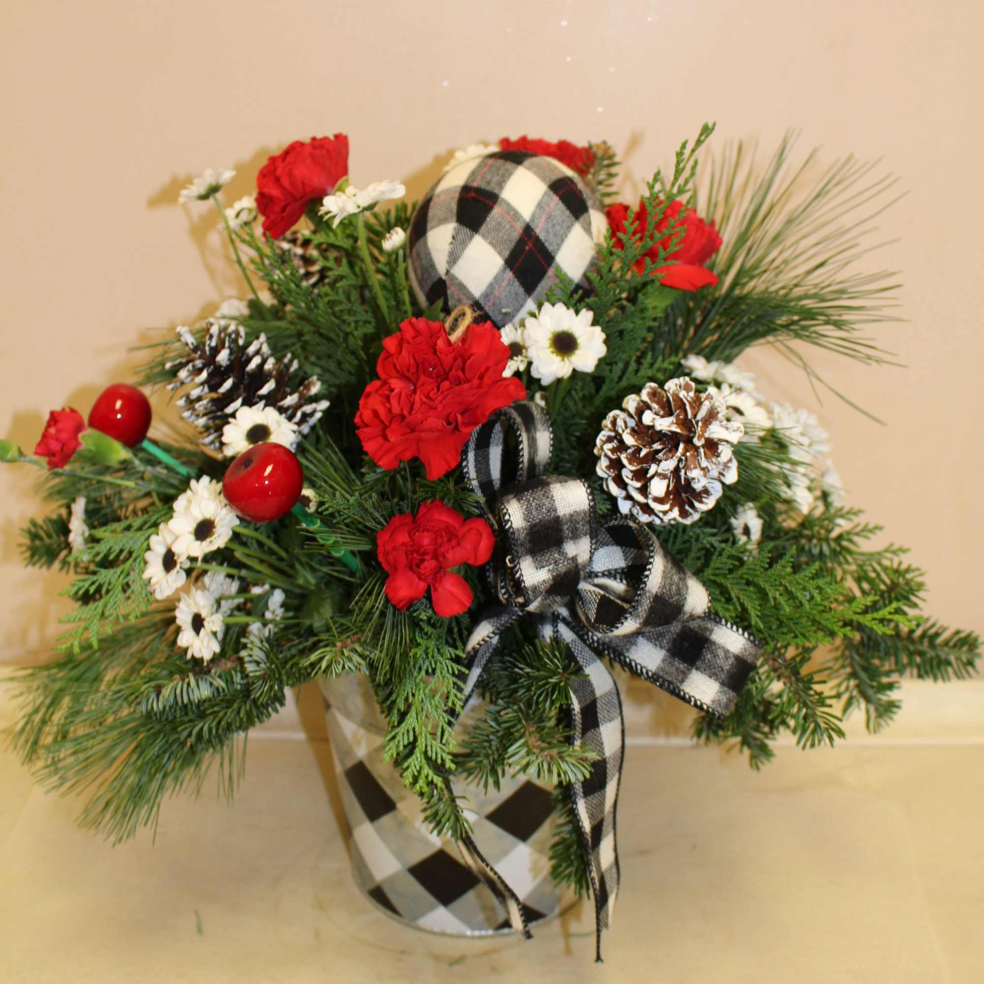 A beautiful holiday arrangement in a black and white galvanized tin