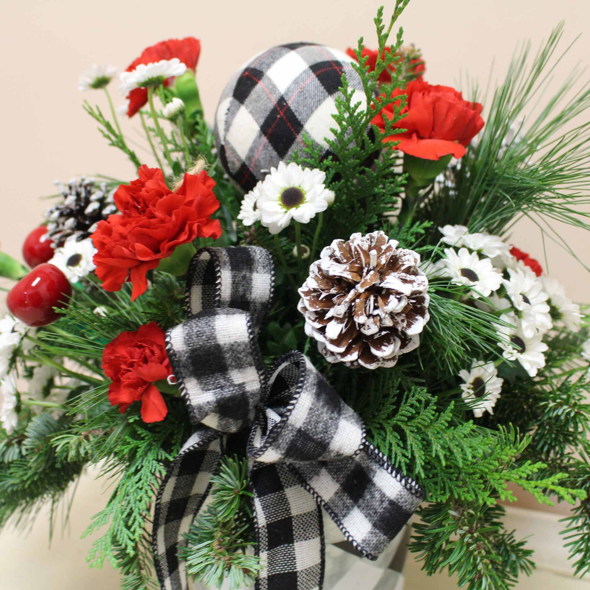 A beautiful holiday arrangement in a black and white galvanized tin