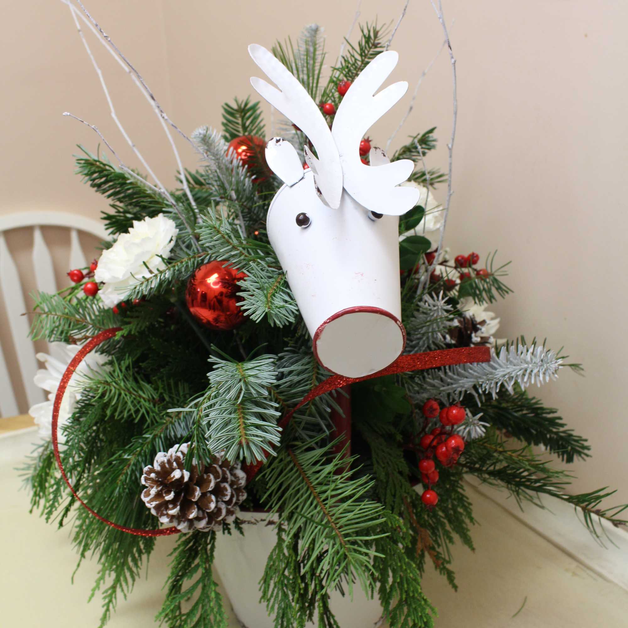 here comes Rudolph is this enamel container featuring a beautiful holiday arrangement