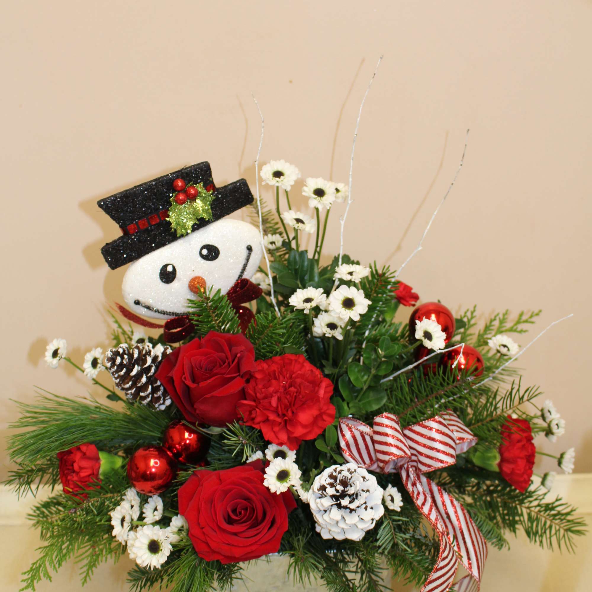 an adorable galvanized basket with a hand painted snowman family, filled with