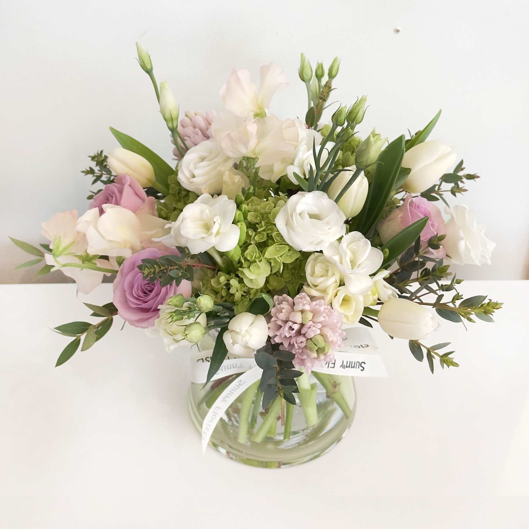 This arrangement is presented in 5.5 pinched clear glass vase. This arrangement