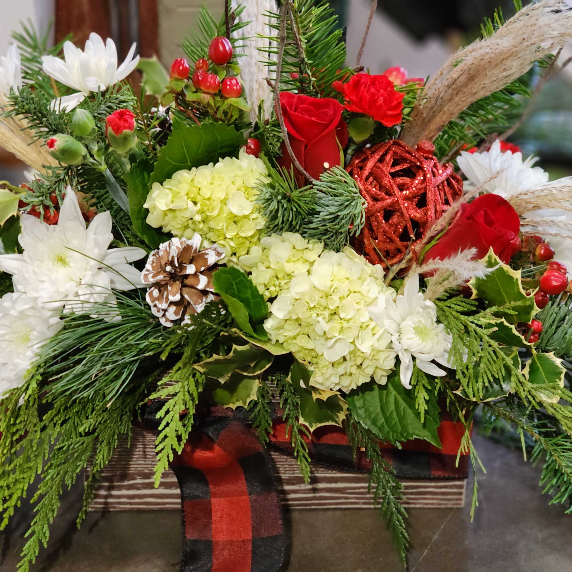 Wooden box tied with ribbon for the scarf effect. Evergreens, berries pinecone
