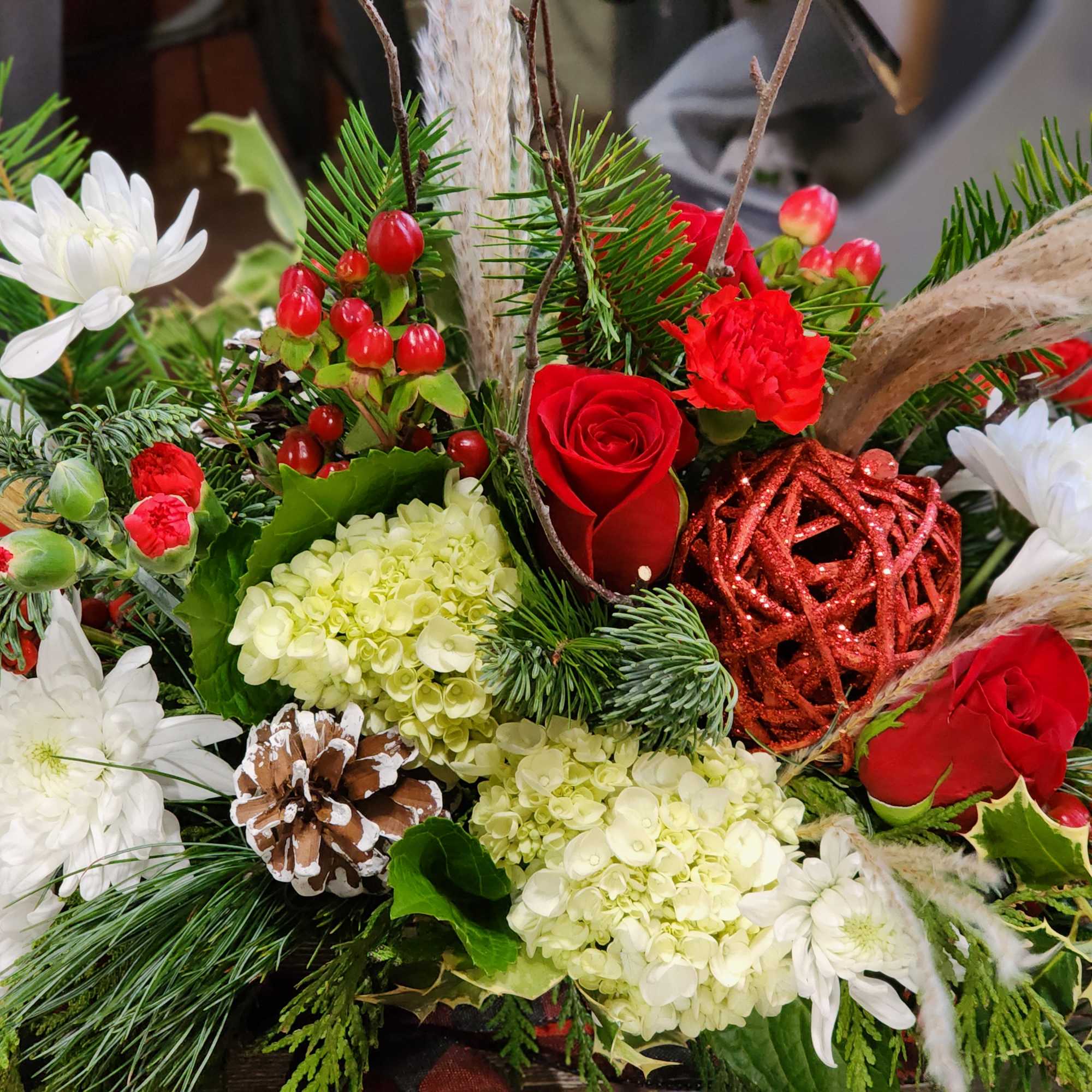 Wooden box tied with ribbon for the scarf effect. Evergreens, berries pinecone