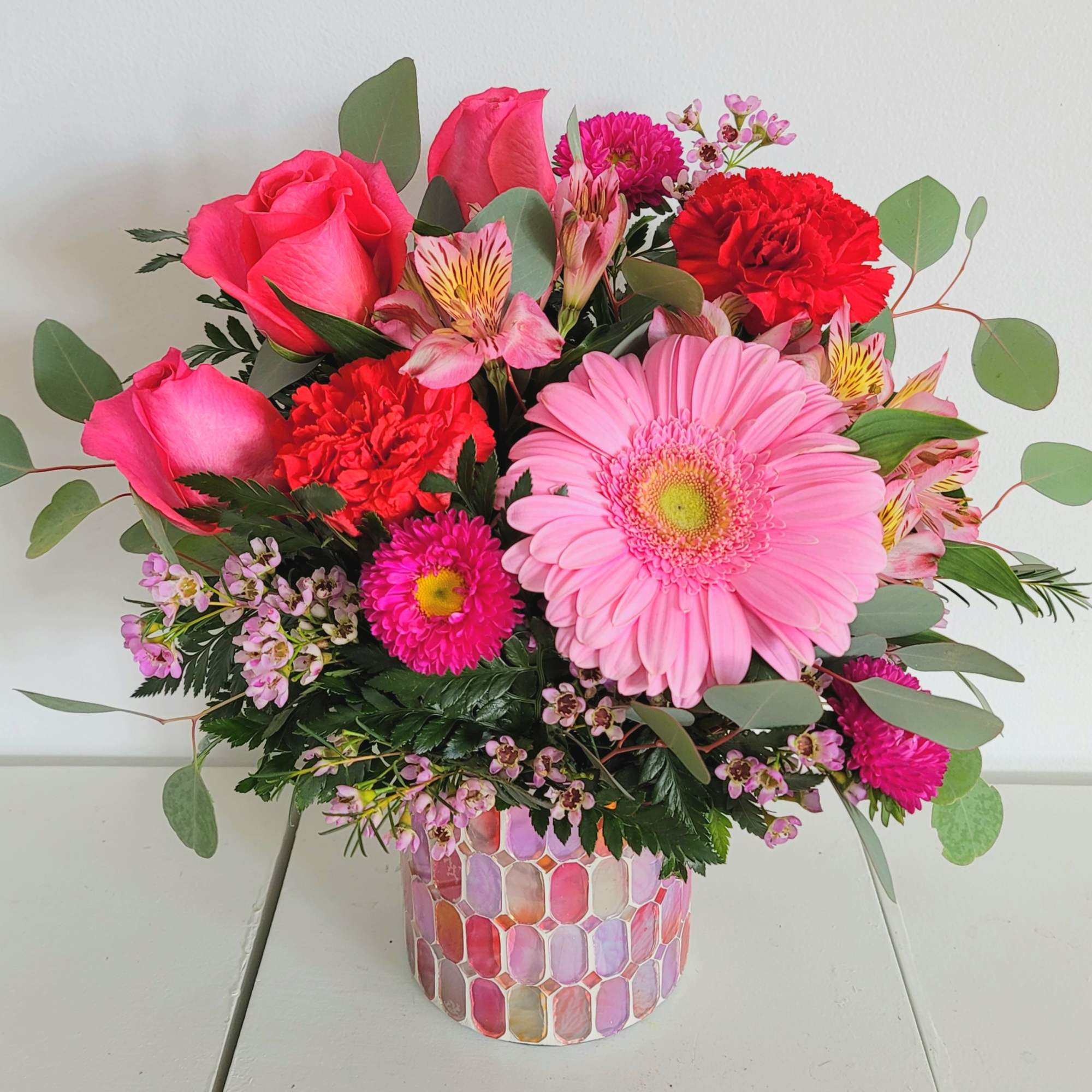 This beautiful purple or pink glass vase can be used as a