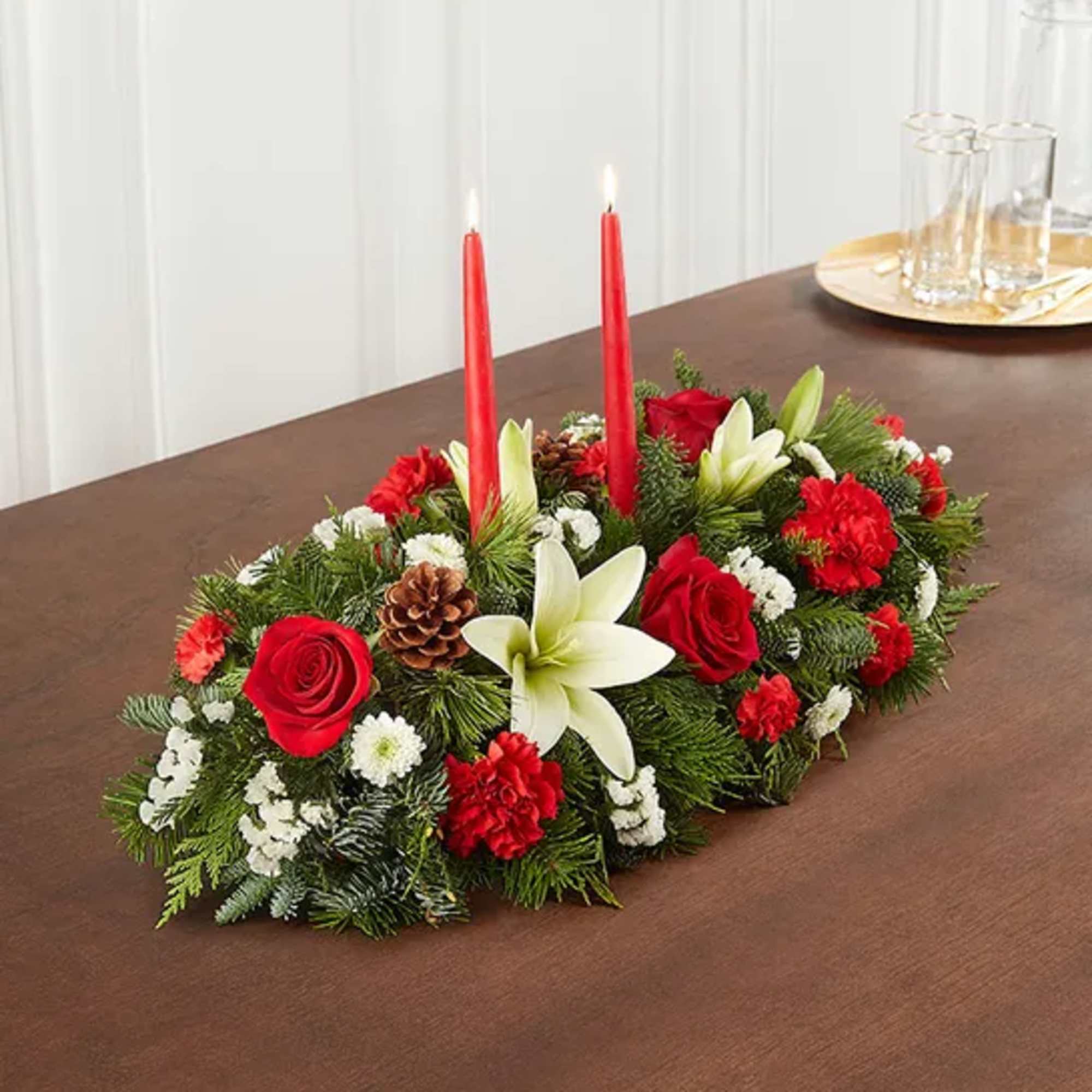 Beautiful long and low centerpiece with white lilies, red roses red carnations