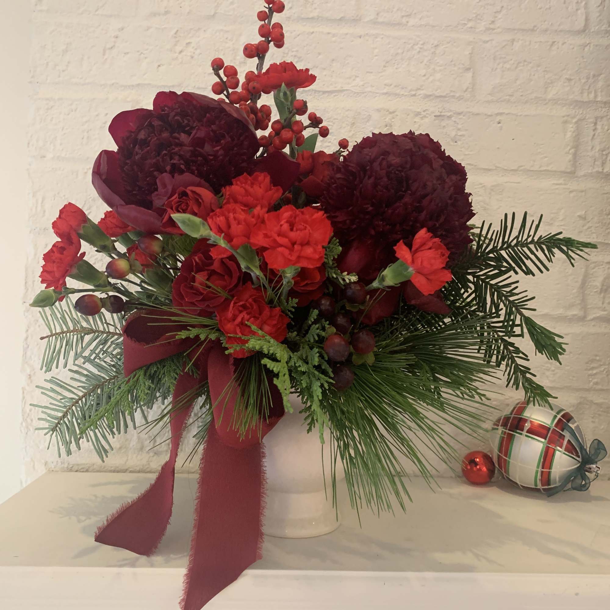 Rudolph Rouge is a bold, monochromatic mix of red blooms, berries, and