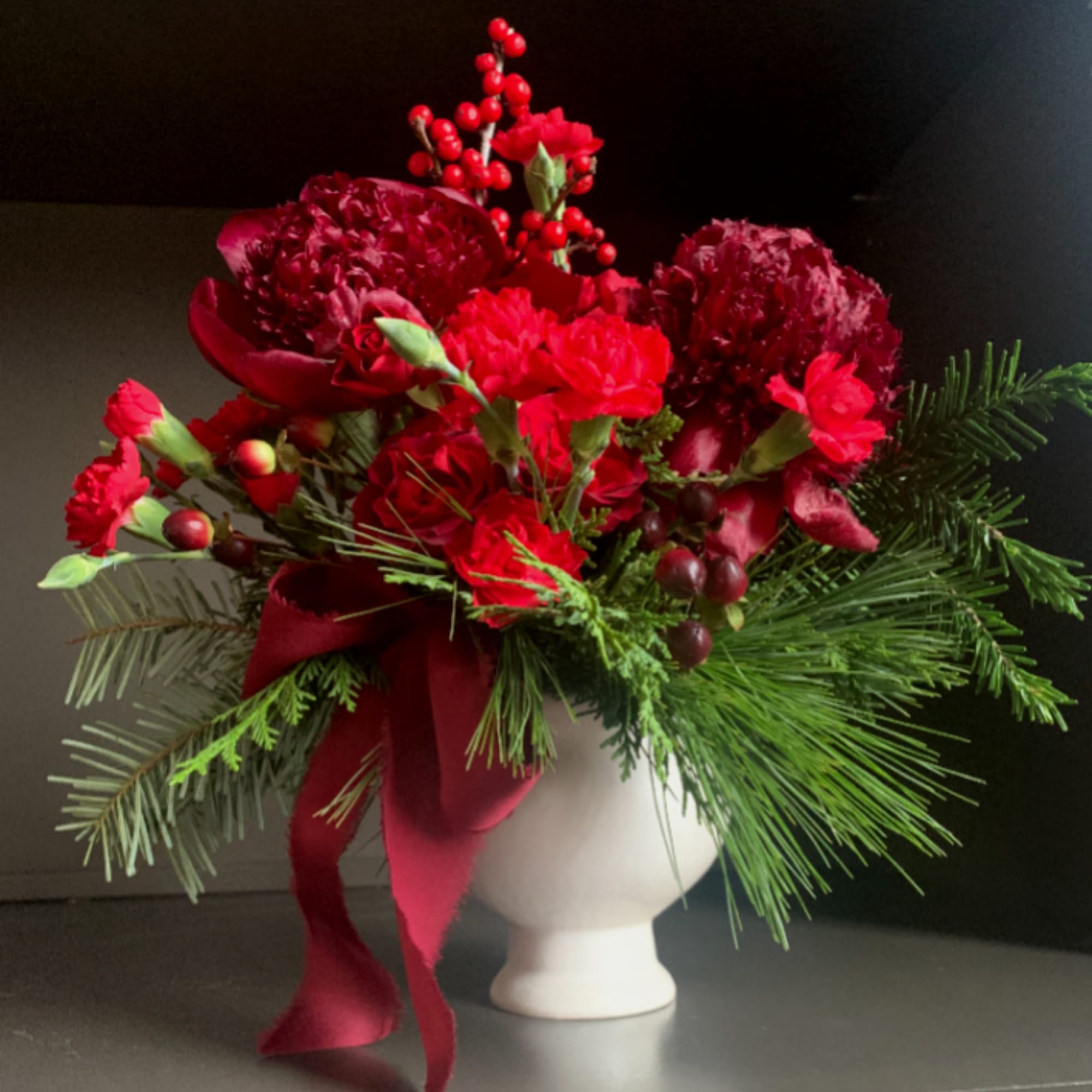 Rudolph Rouge is a bold, monochromatic mix of red blooms, berries, and