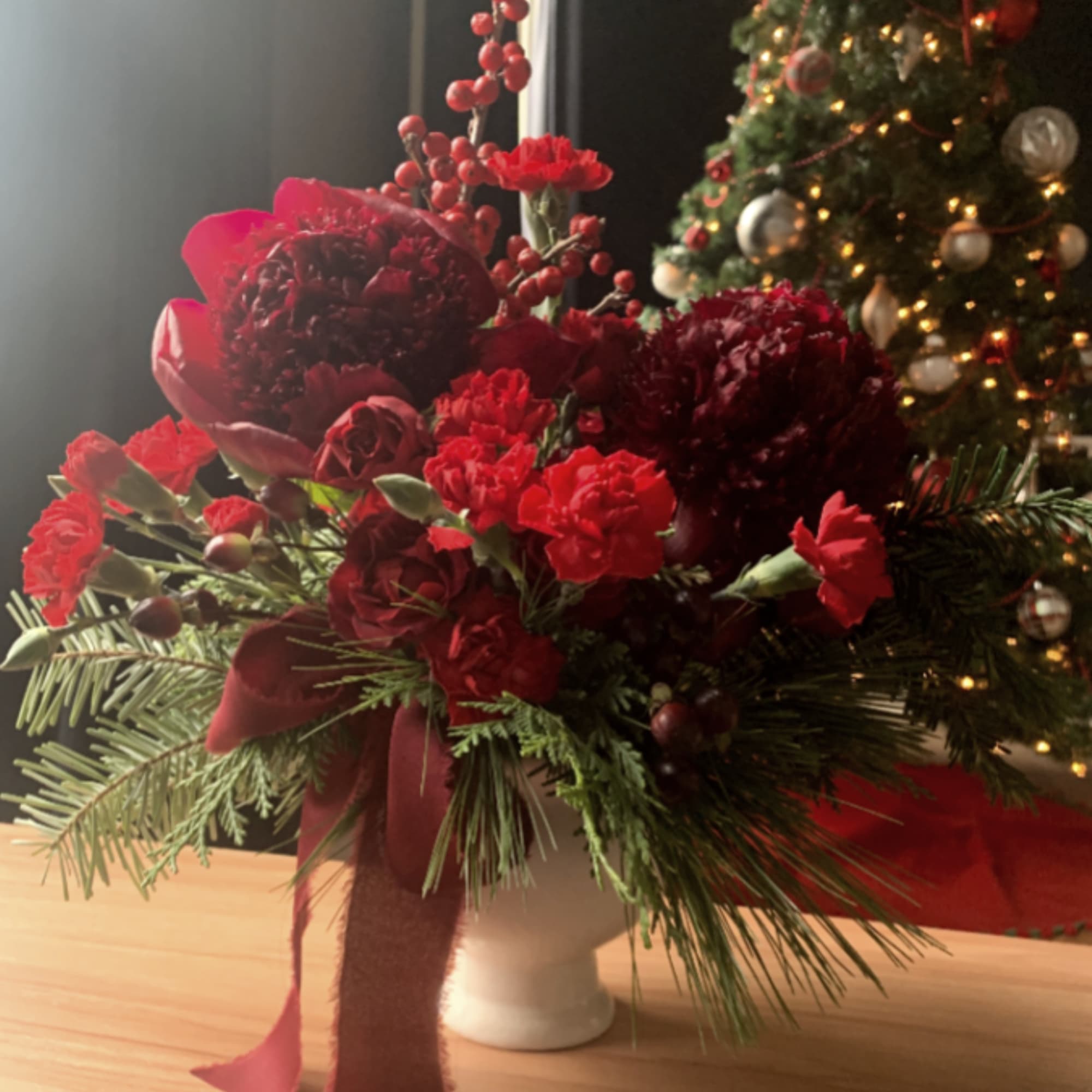 Rudolph Rouge is a bold, monochromatic mix of red blooms, berries, and