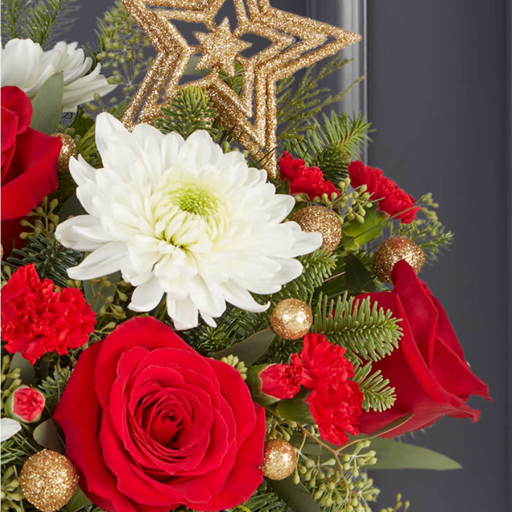 The joy of gift-giving comes alive in our bright and festive arrangement.
