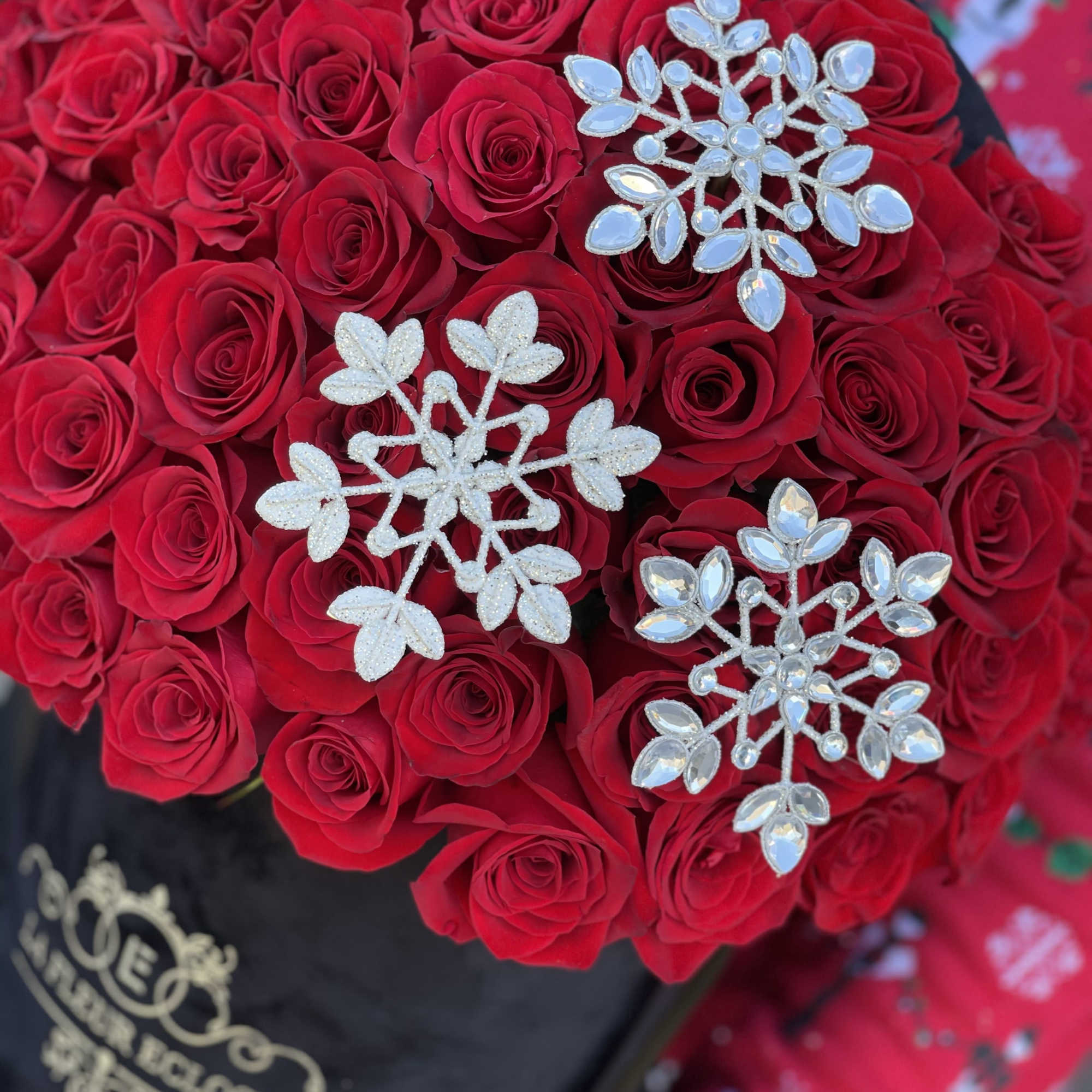 Standard 75 roses in our signature black  box with snow flakes
