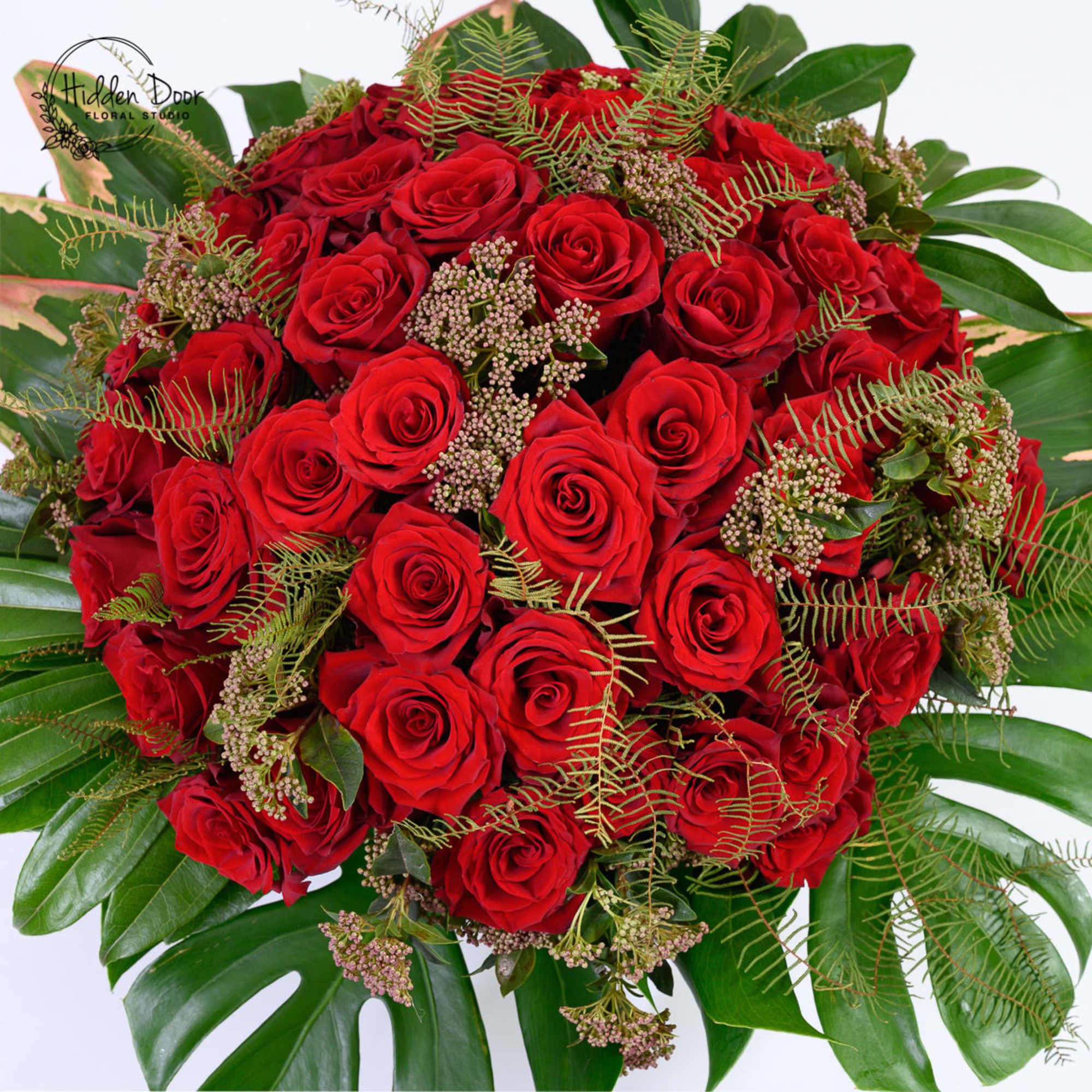 
Crimson is a bold, luxurious arrangement featuring a dense cluster of premium