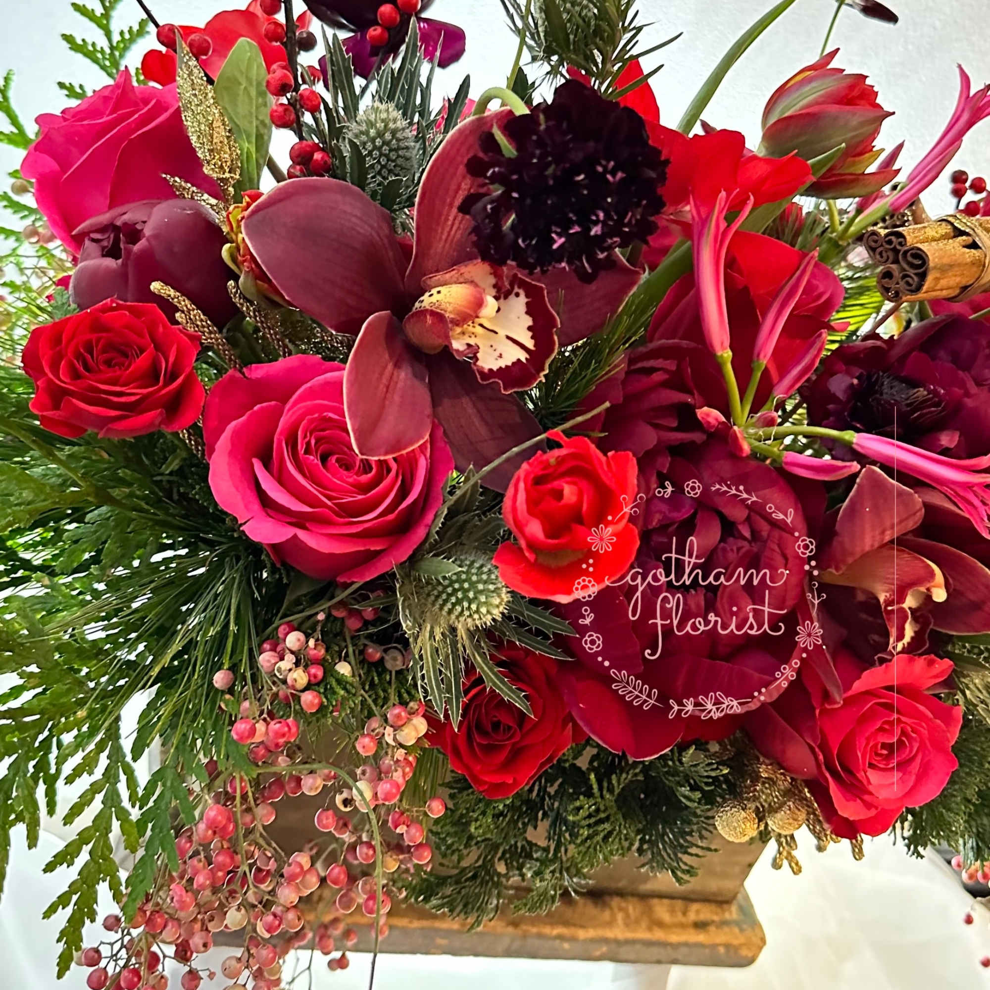 Wood planter filled with seasonal flowers and sparkly holiday decorations. Color can
