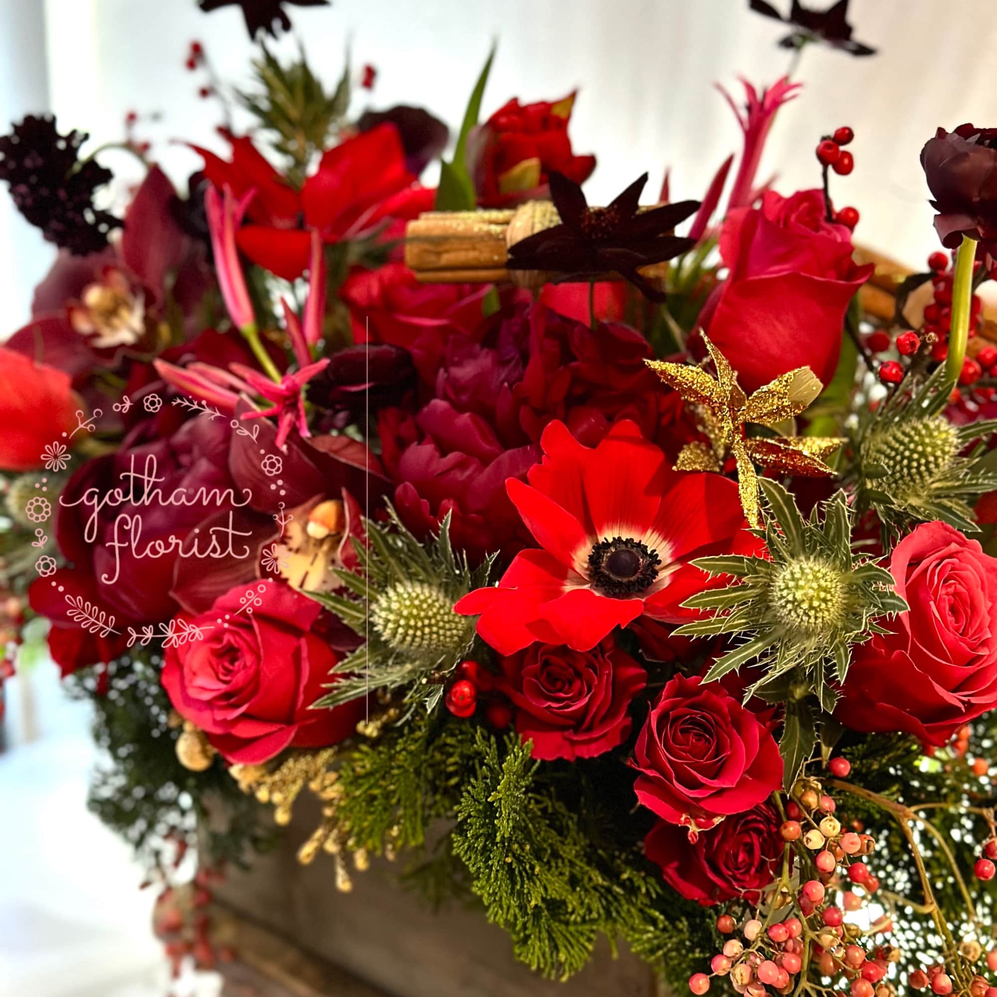 Wood planter filled with seasonal flowers and sparkly holiday decorations. Color can
