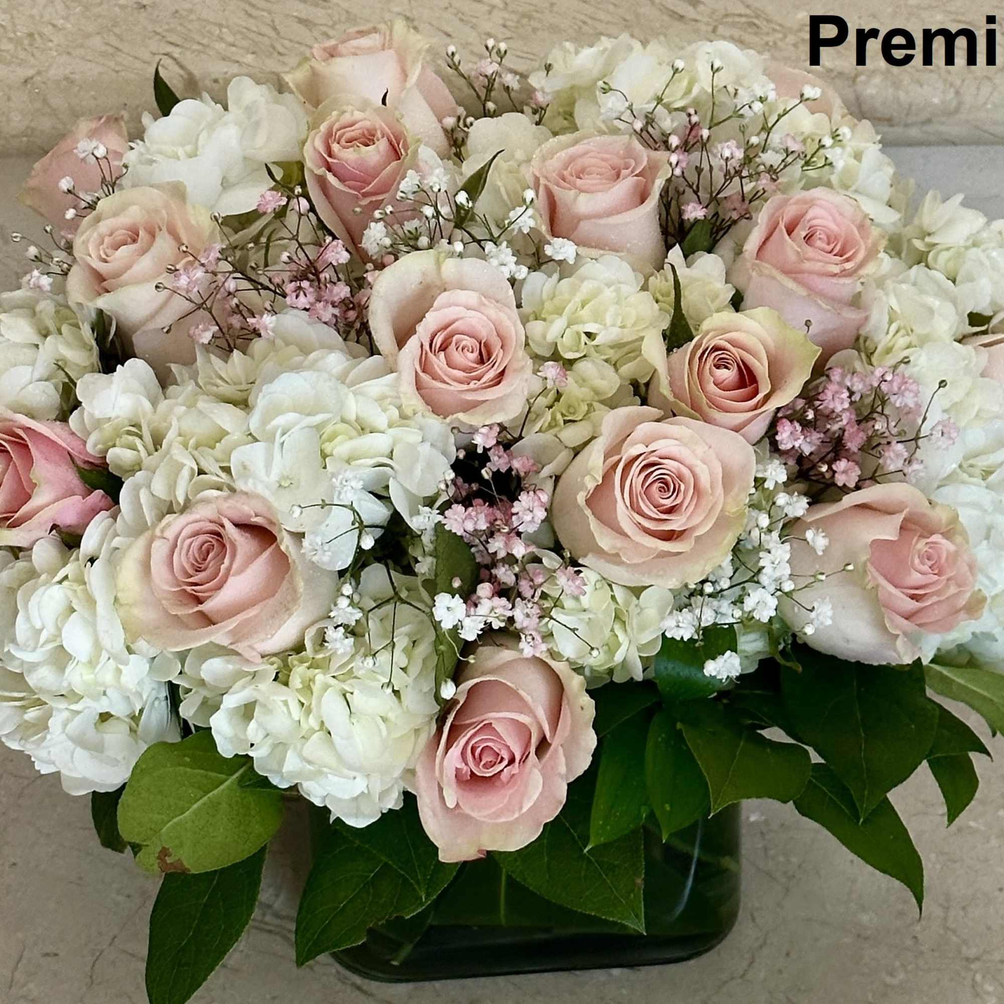 Pink Roses with White Hydrangeas arranged in a square glass vase.