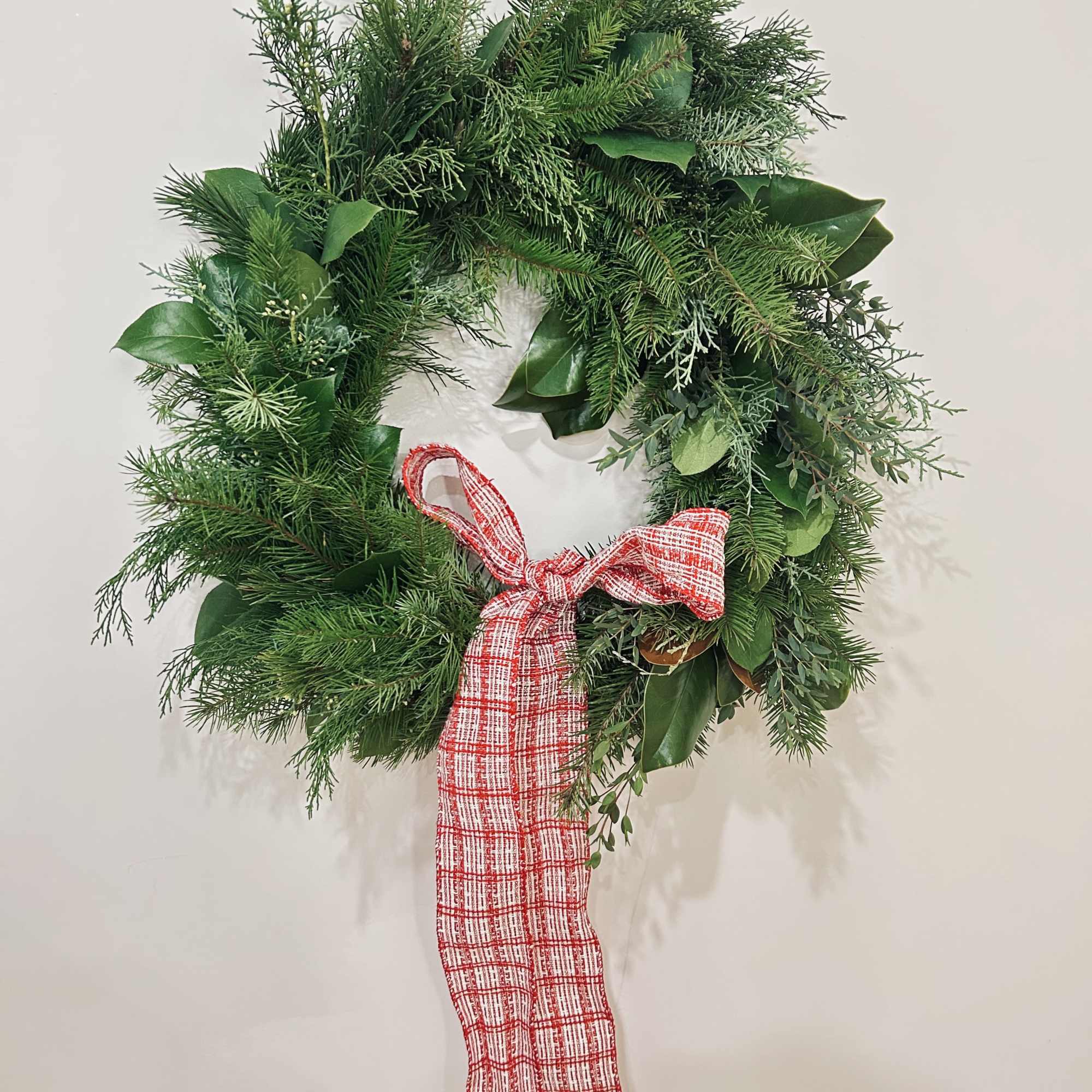 Wreath is available in one size. Decorated with Christmas greenery, ribbons, &amp;