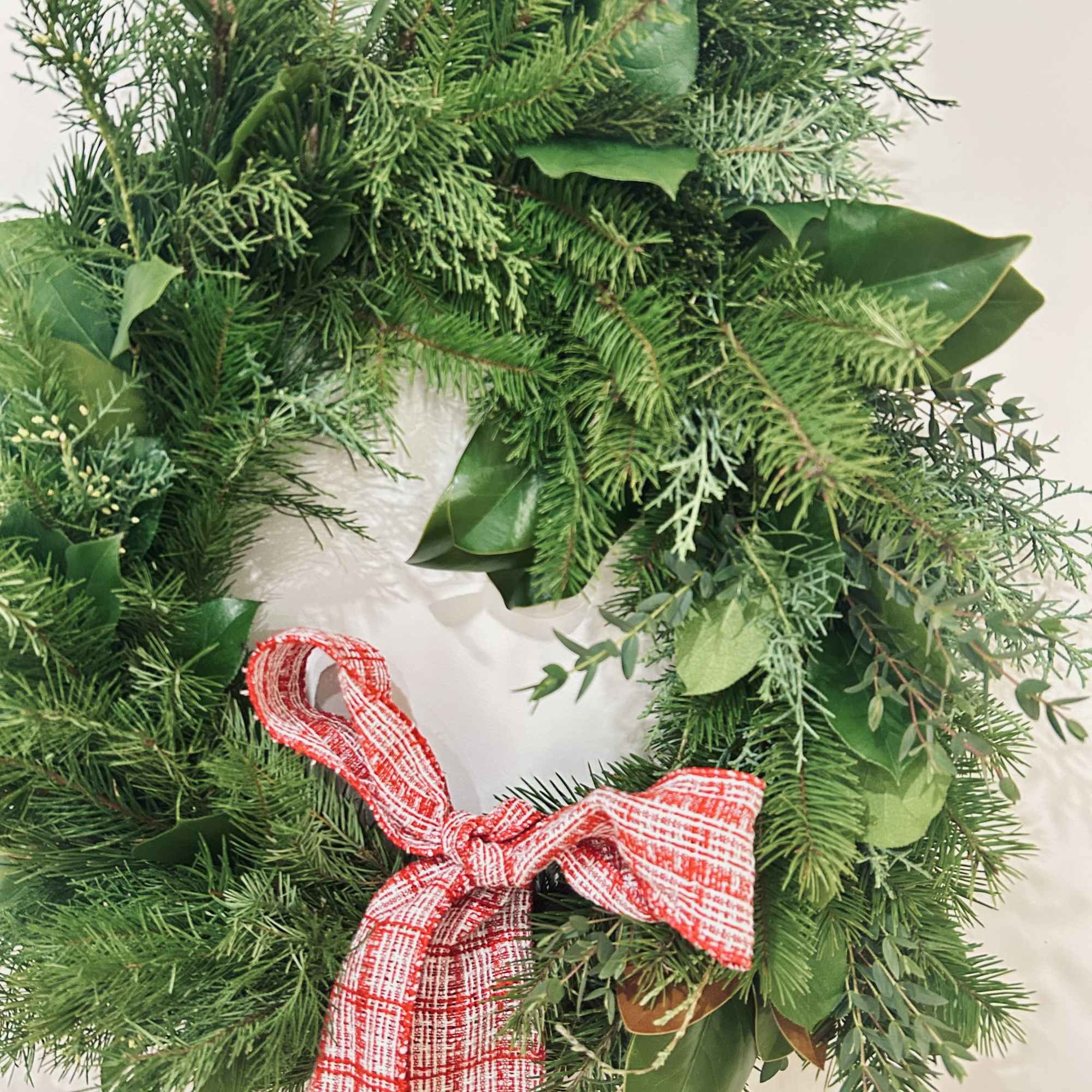 Wreath is available in one size. Decorated with Christmas greenery, ribbons, &amp;
