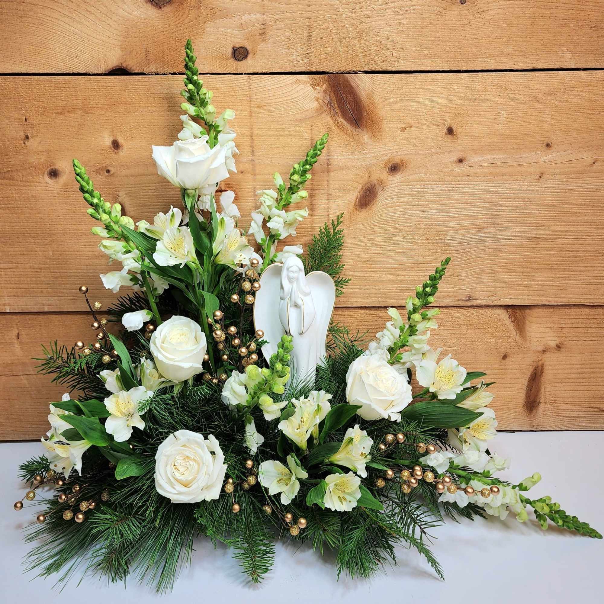 The Heavenly Peace Arrangement is a gorgeous design of white blooms including