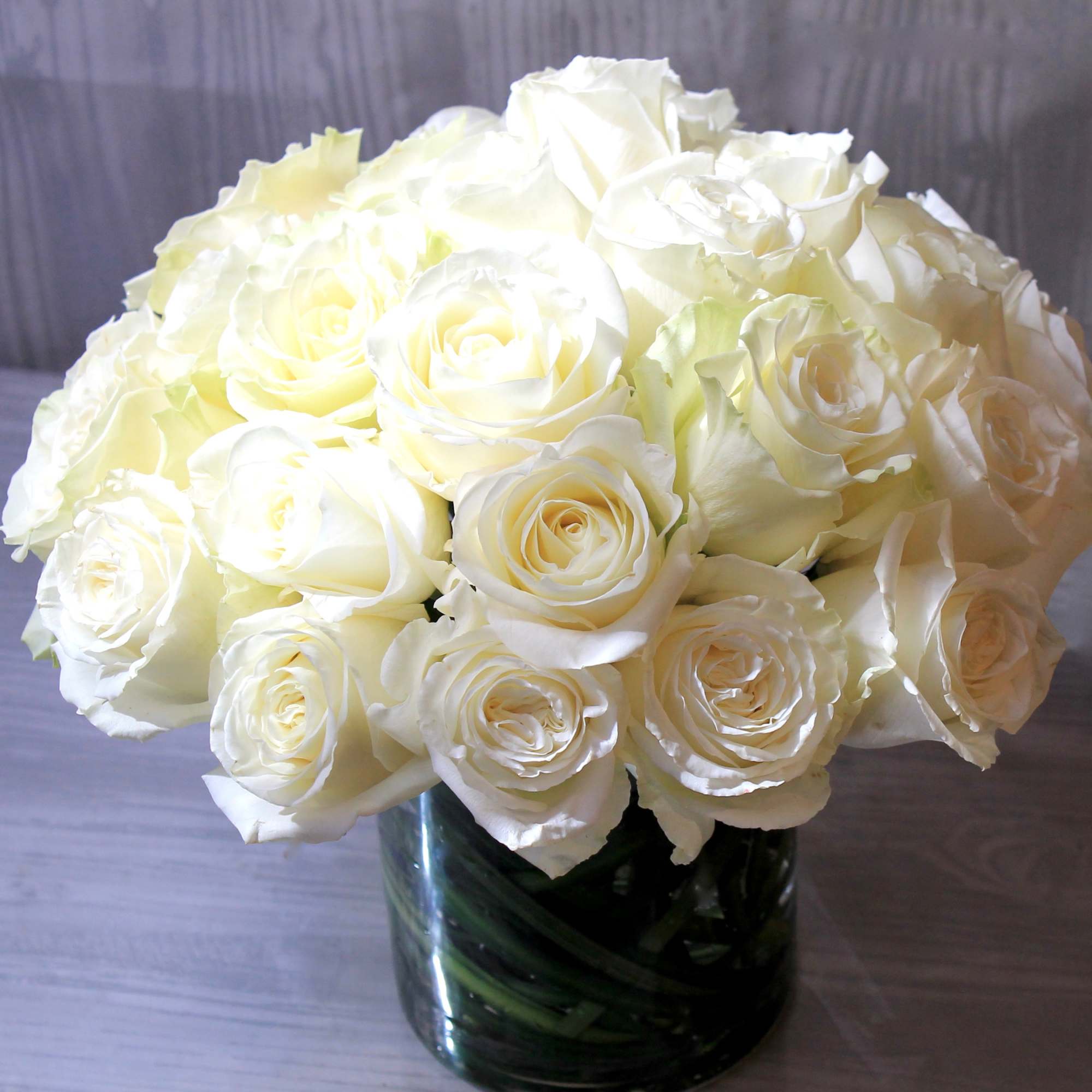 Make a bold statement with this elegantly simple design. White roses symbolize