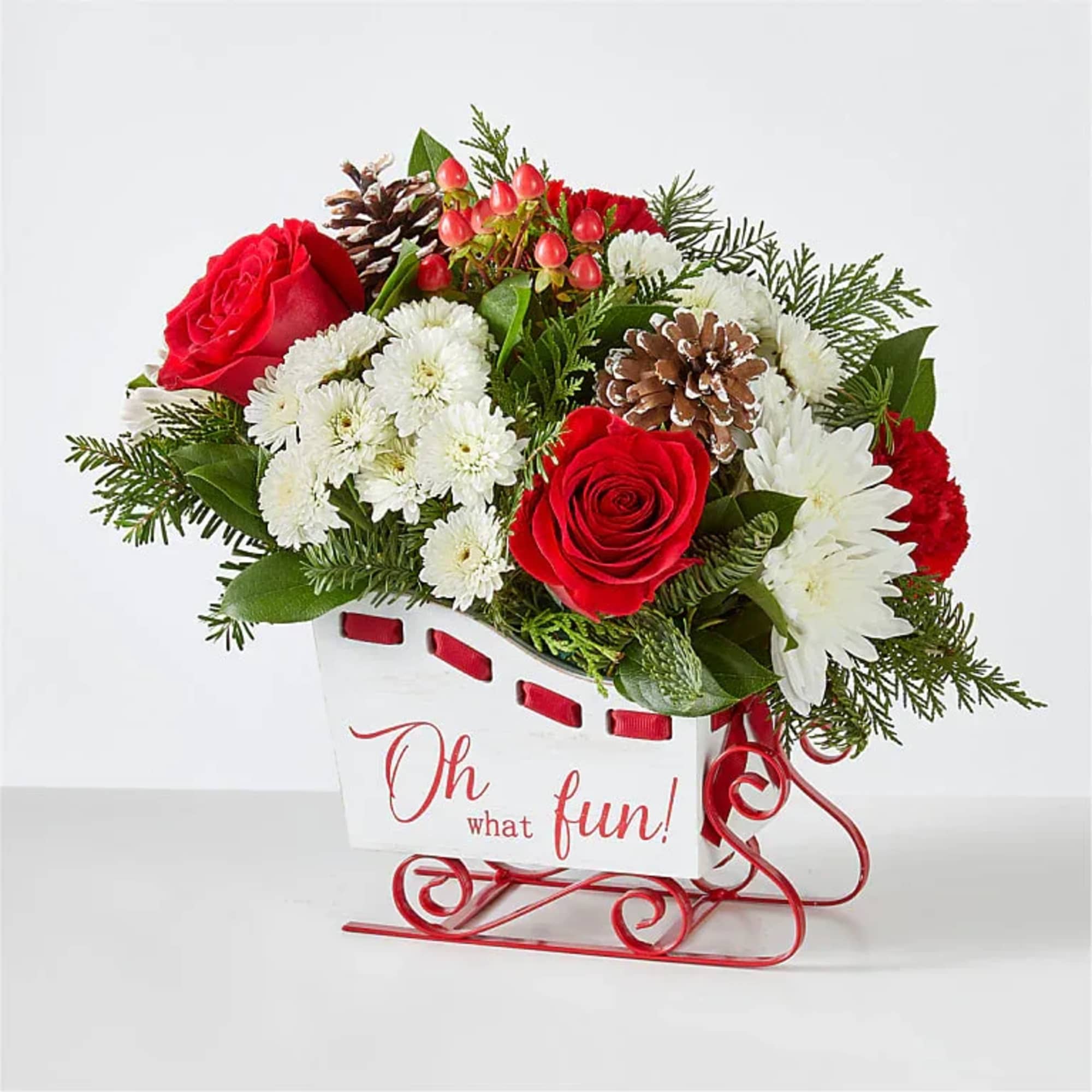 Sled into the holiday season with this lush arrangement of red roses
