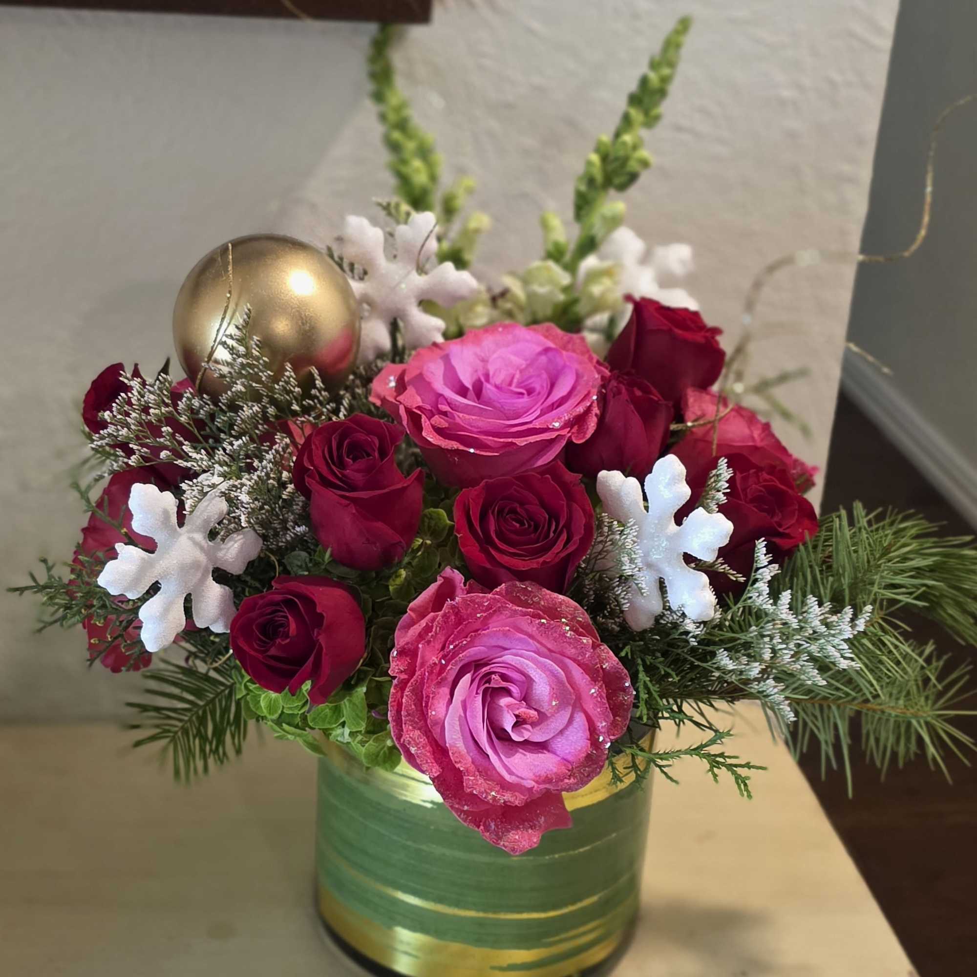 Beautiful sparkle pink roses with red roses, holiday greens and ornaments. It's