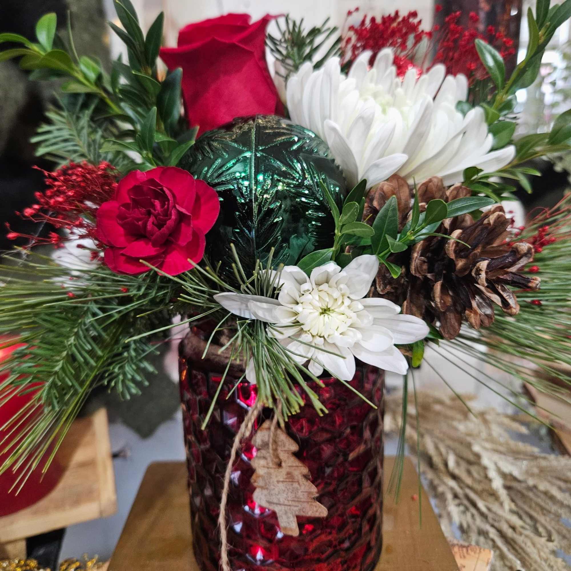 Fun winter container with red roses, mini carnations, white chrysanthemums pine and