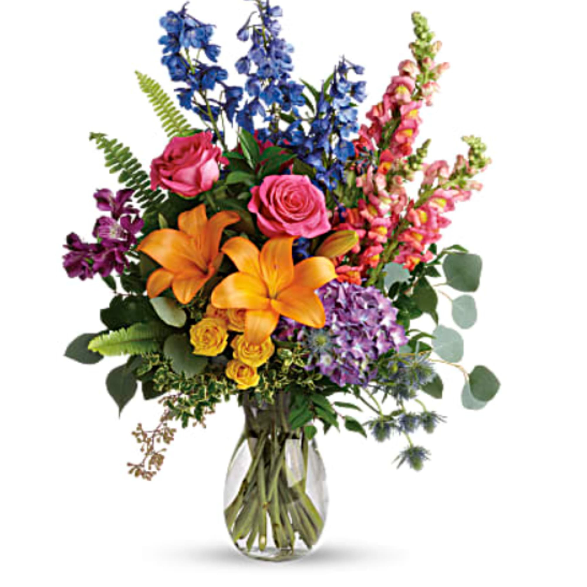 This colorful bouquet includes purple hydrangea, pink roses, yellow spray roses, orange