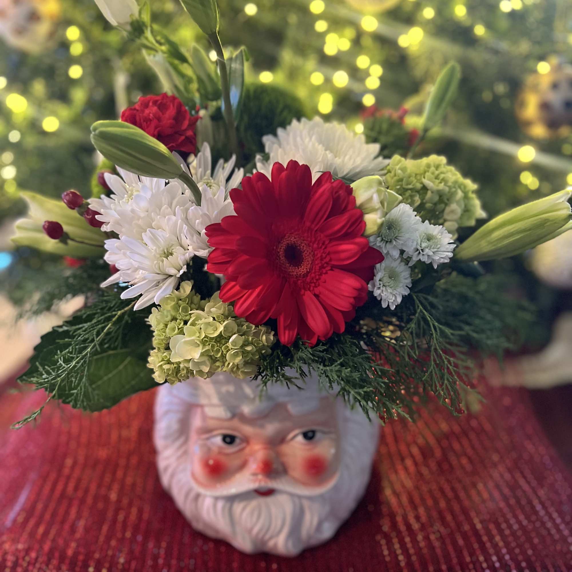 Designers Choice of Christmas florals placed on a large decorative &ldquo;SANTA CLAUSE&rdquo;
