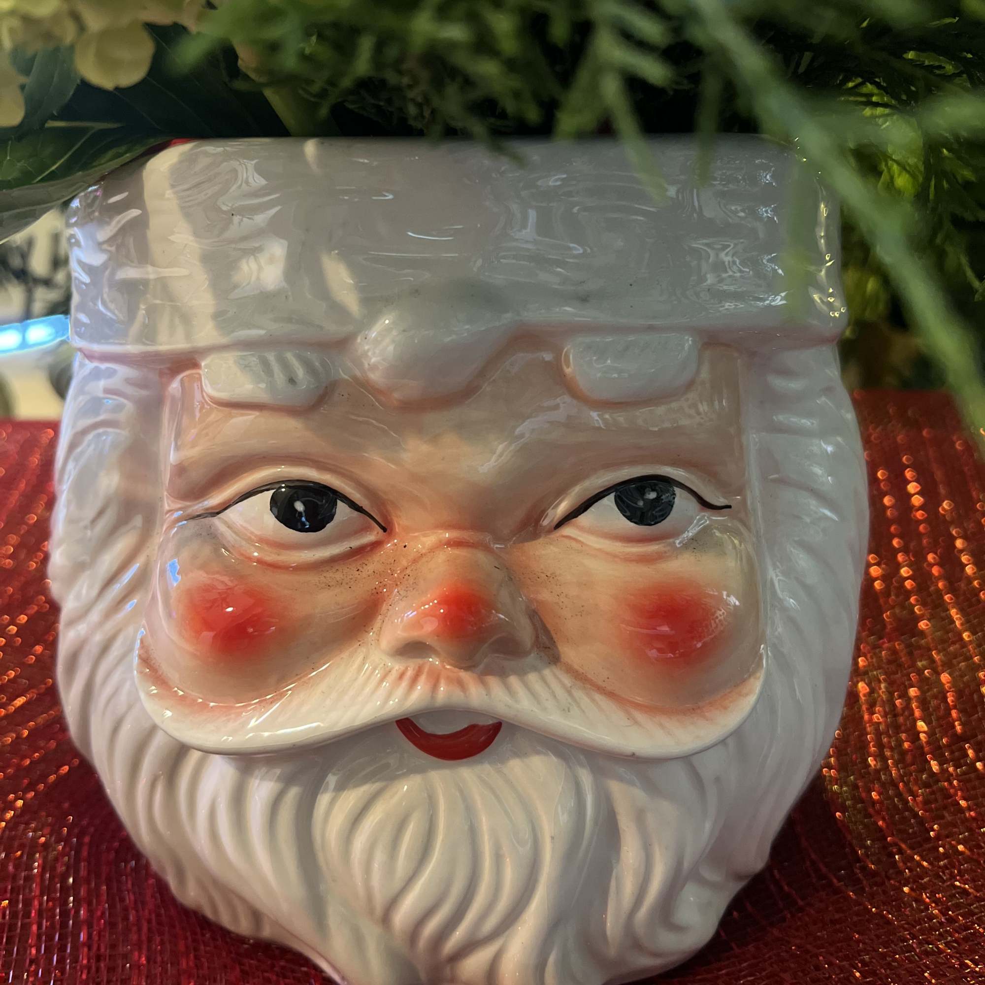 Designers Choice of Christmas florals placed on a large decorative &ldquo;SANTA CLAUSE&rdquo;