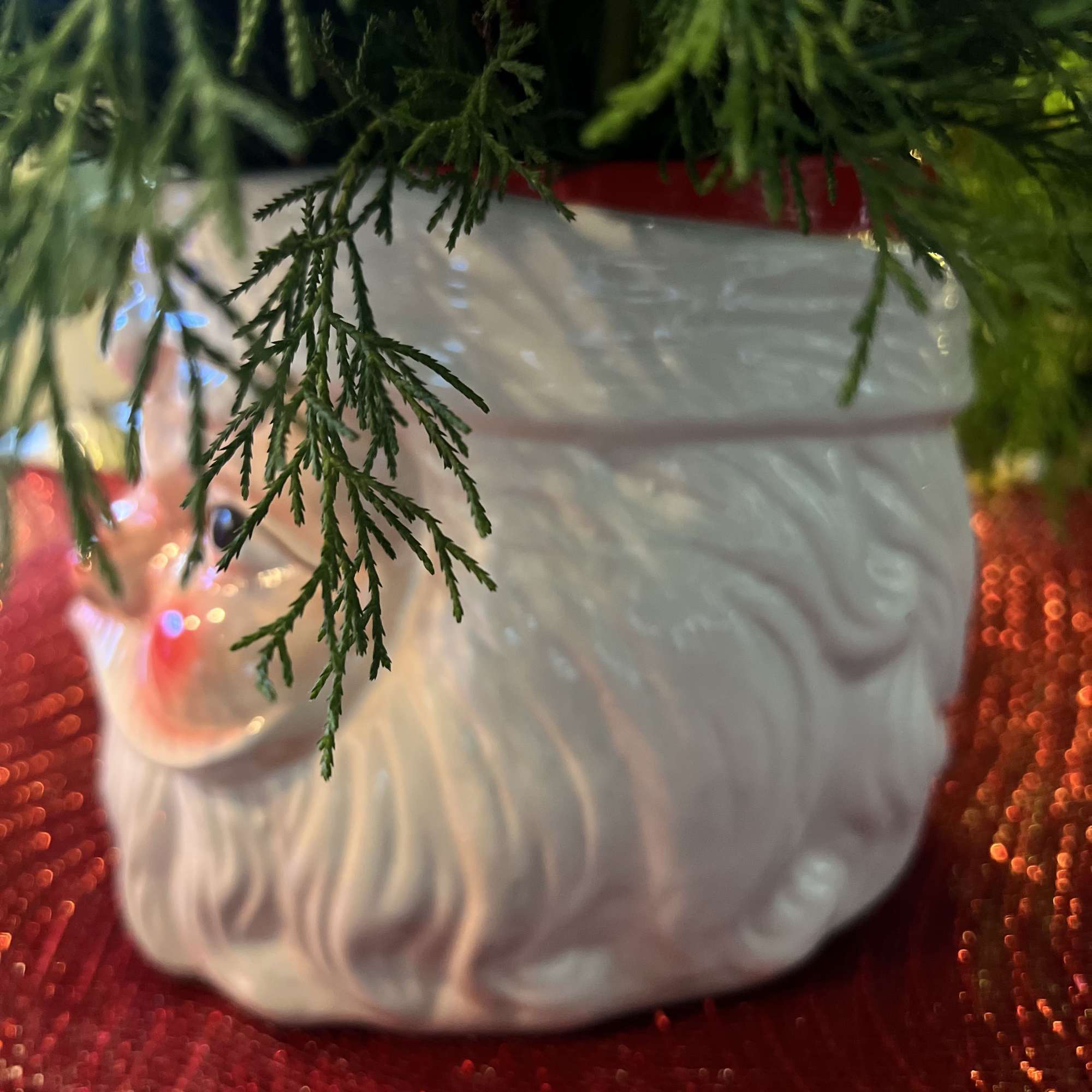 Designers Choice of Christmas florals placed on a large decorative &ldquo;SANTA CLAUSE&rdquo;