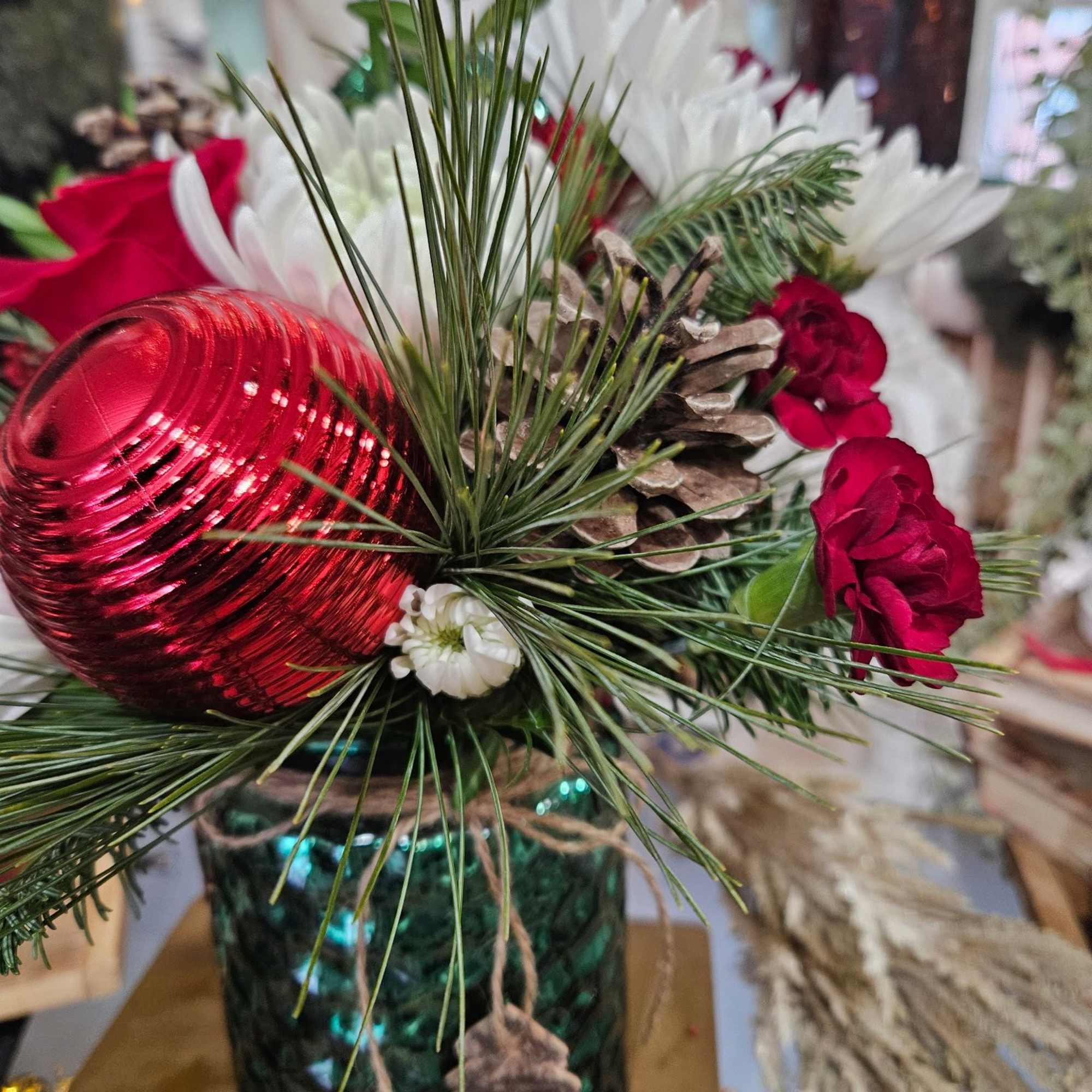 Fun winter container with red roses, mini carnations, white chrysanthemums pine and